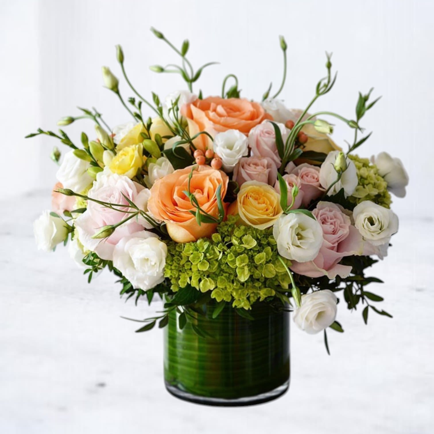 Paloma Bloom Paloma Bloom - A radiant expression of calm and charm, Paloma Bloom features a graceful medley of peach, blush, white, and soft yellow blooms. Nestled in a modern glass cylinder lined with foliage, this floral arrangement showcases premium roses, lisianthus, delicate hydrangea, and seasonal textural accents for a fresh and uplifting look. Perfect for birthdays, celebrations, or just because, Paloma Bloom adds a light, sophisticated touch to any moment worth honoring. Same-day flower delivery available throughout Houston and surrounding areas.