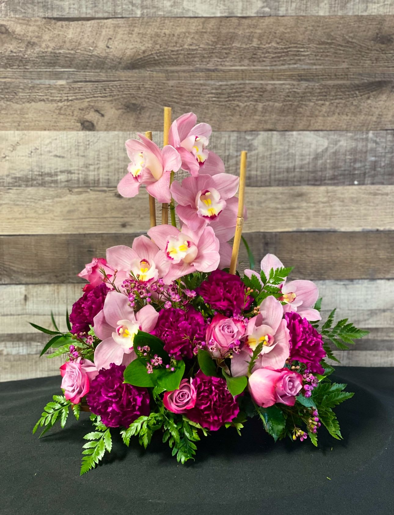 Island Princess - Stunning modern styled orchid arrangement with a mix of other purple &amp; lavender blooms. Perfect to celebrate any special occasion. 