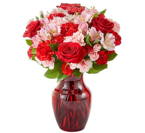 Candy Kisses Bouquet Candy Kisses Bouquet - Sweeten their day with Candy Kisses Bouquet! A delightful mix of red roses, pink alstroemeria, and vibrant carnations create a heartwarming display of love and affection. Arranged in a ruby-red glass vase, this charming bouquet is the perfect way to send a kiss of sweetness for any occasion!