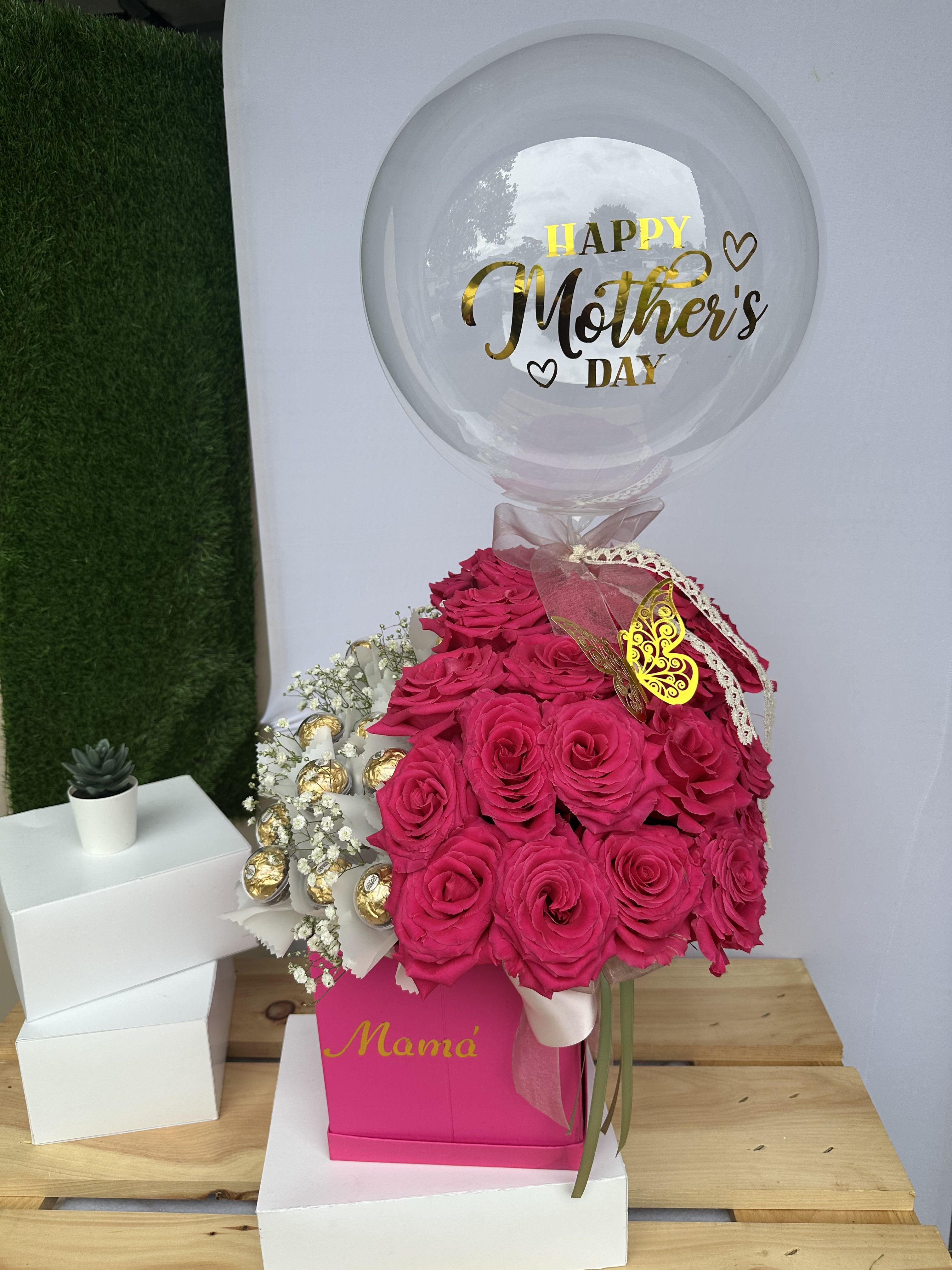 Magenta Magenta - In a decorated pink box, a combination of 2 dozen pink roses and 2 dozen Ferrero Rocher with a beautiful, personalized bubble balloon.
