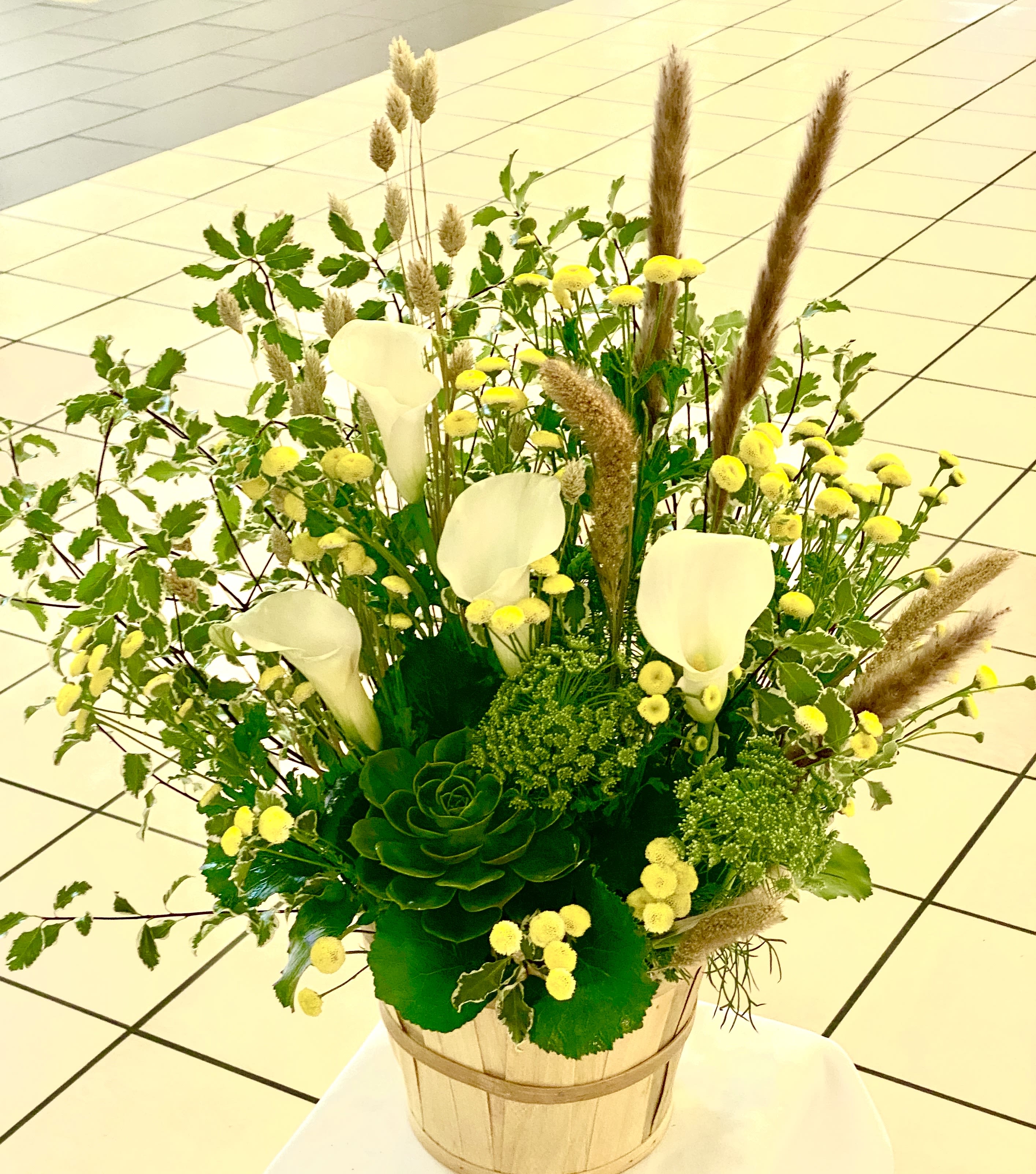 Garden green - A green basket with a pop of Yellow and White calla lily this arrangement can only be described as refreshing. Send it to say thank you and to show your appreciation!  Approximate Dimensions: 15&quot;D x 12&quot;H