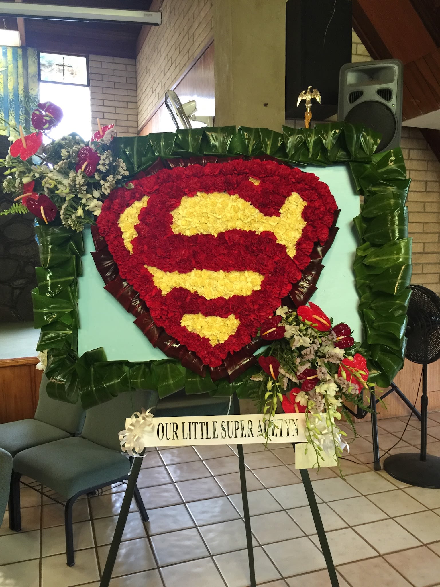 Custom Shield Wreath - W20010 - Custom shield wreath using carnations with anthurium and orchid cascade.  