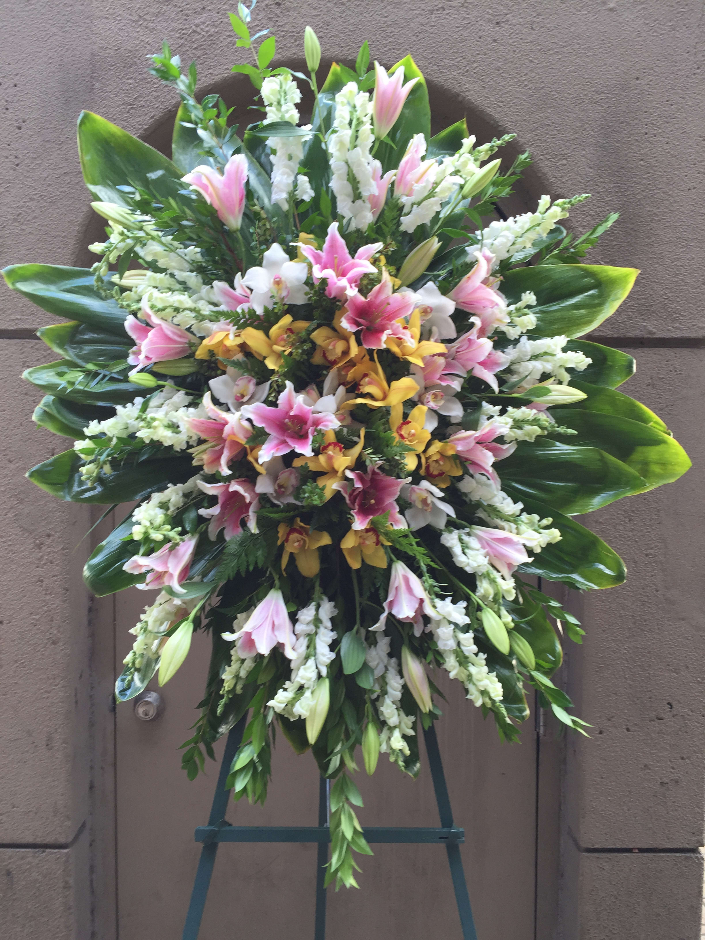 Spring Mix Blossoms Wreath -  F200W06 - Soft pastel of spring like mixes consist of tiger lilies, dendrobium orchids, snapdragons and ti leaves surround.