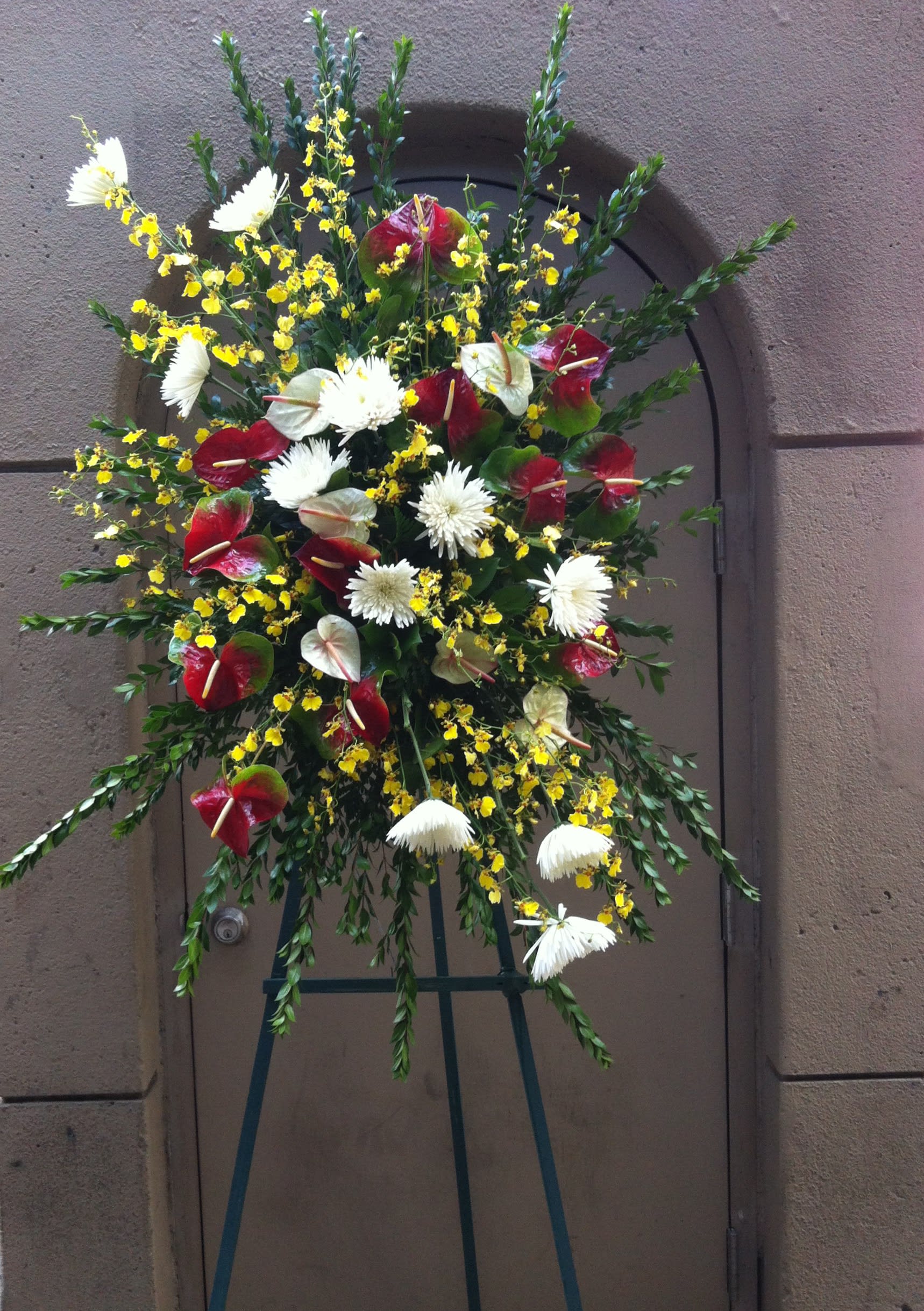 Asymmetric  Wreath of White Chrysanthemums and Red Anthurium - F175W04 - Red, white and yellow theme of white chrysanthemums and red antherium with splices yellow popcorn orchids throughout adding interest and sparks. Please inquire with designer for customization 