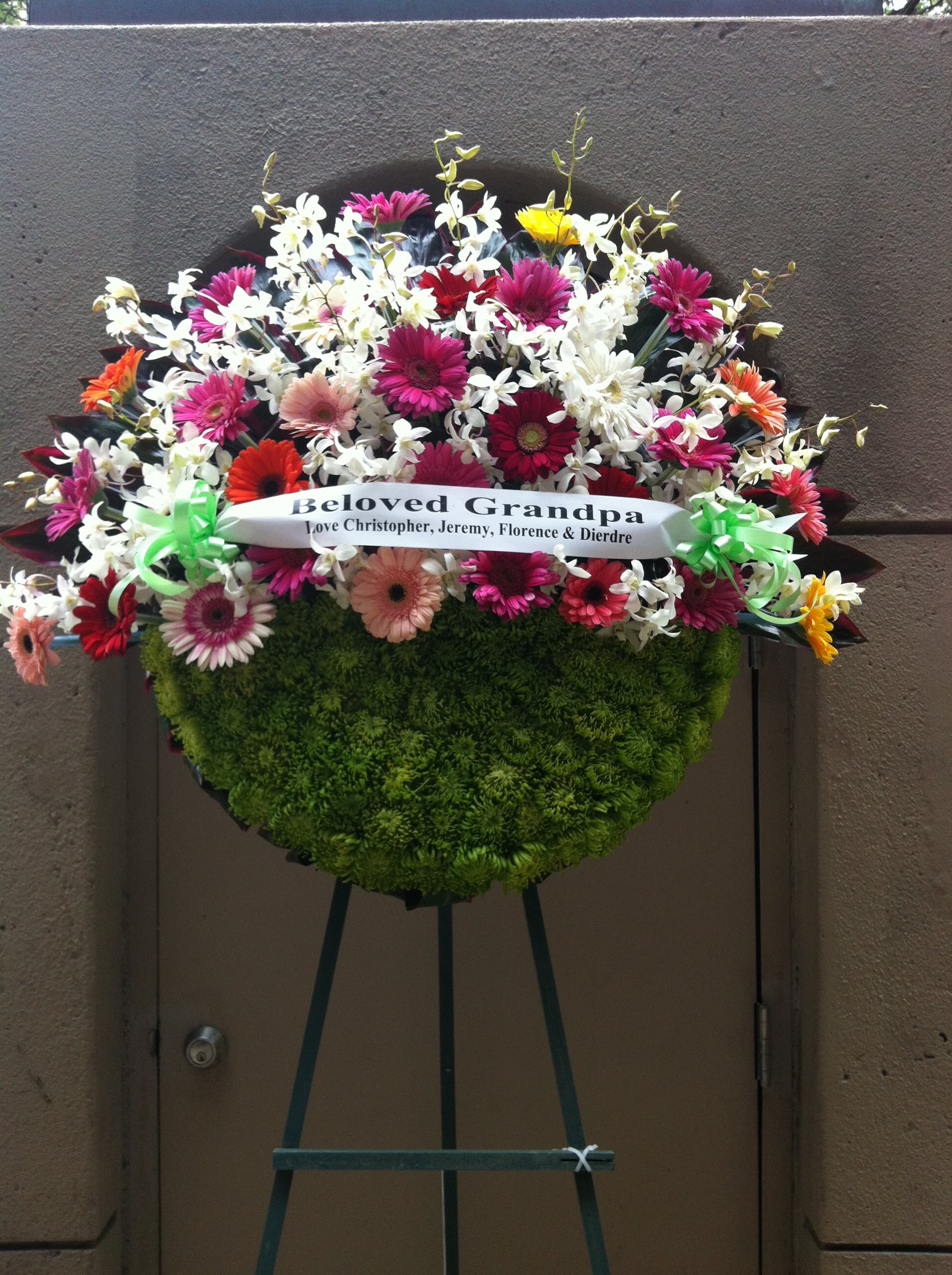 Mix spring flowers and orchids on half moon wreath - F35013 - Half moon creation with vibrant mixes of spring flowers &amp; orchids 