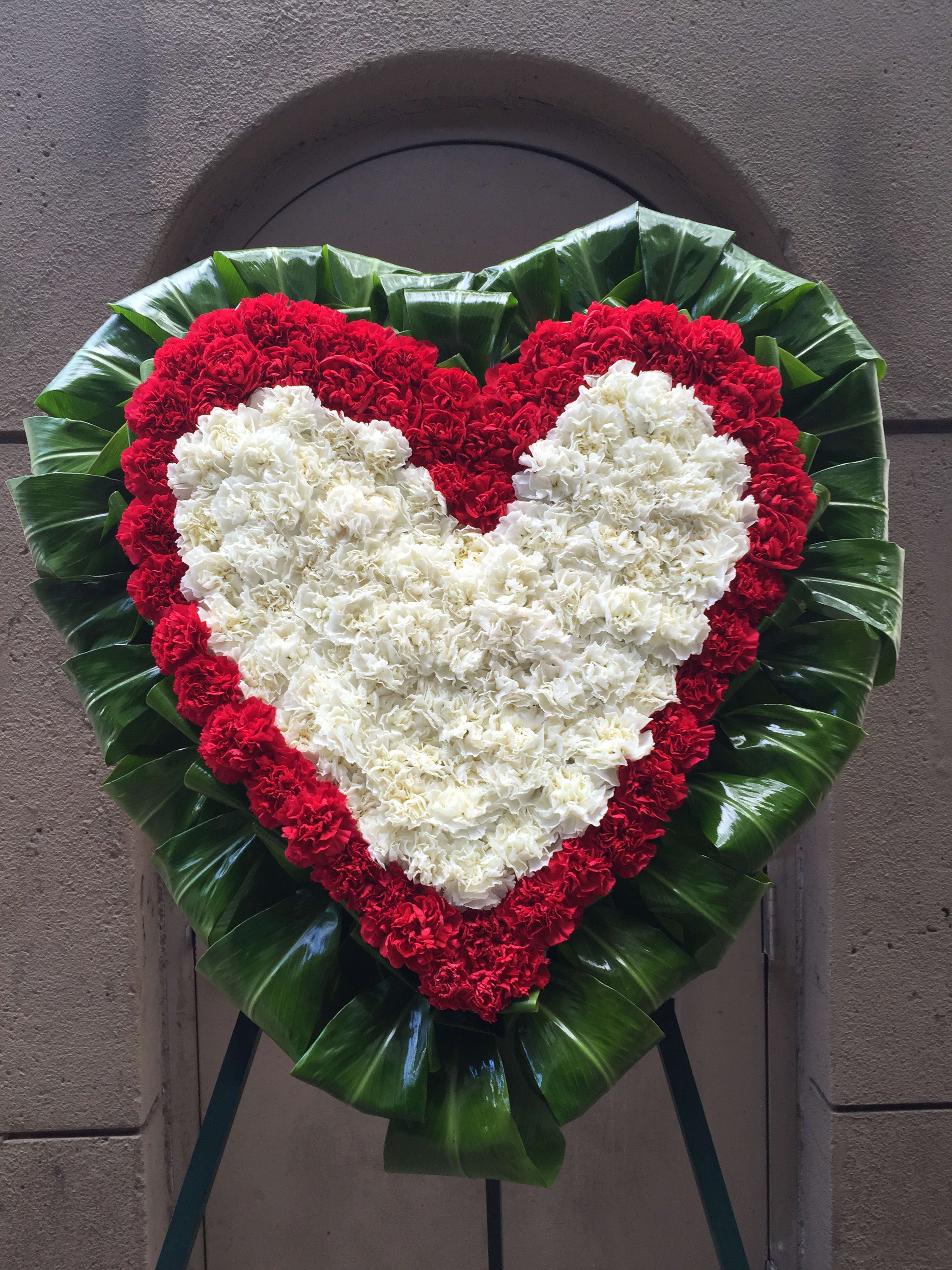 White heart on red heart Carnations with Ti leaves surround wreath - F30009 - Heart on heart, white on red Carnations with Ti leaves surround
