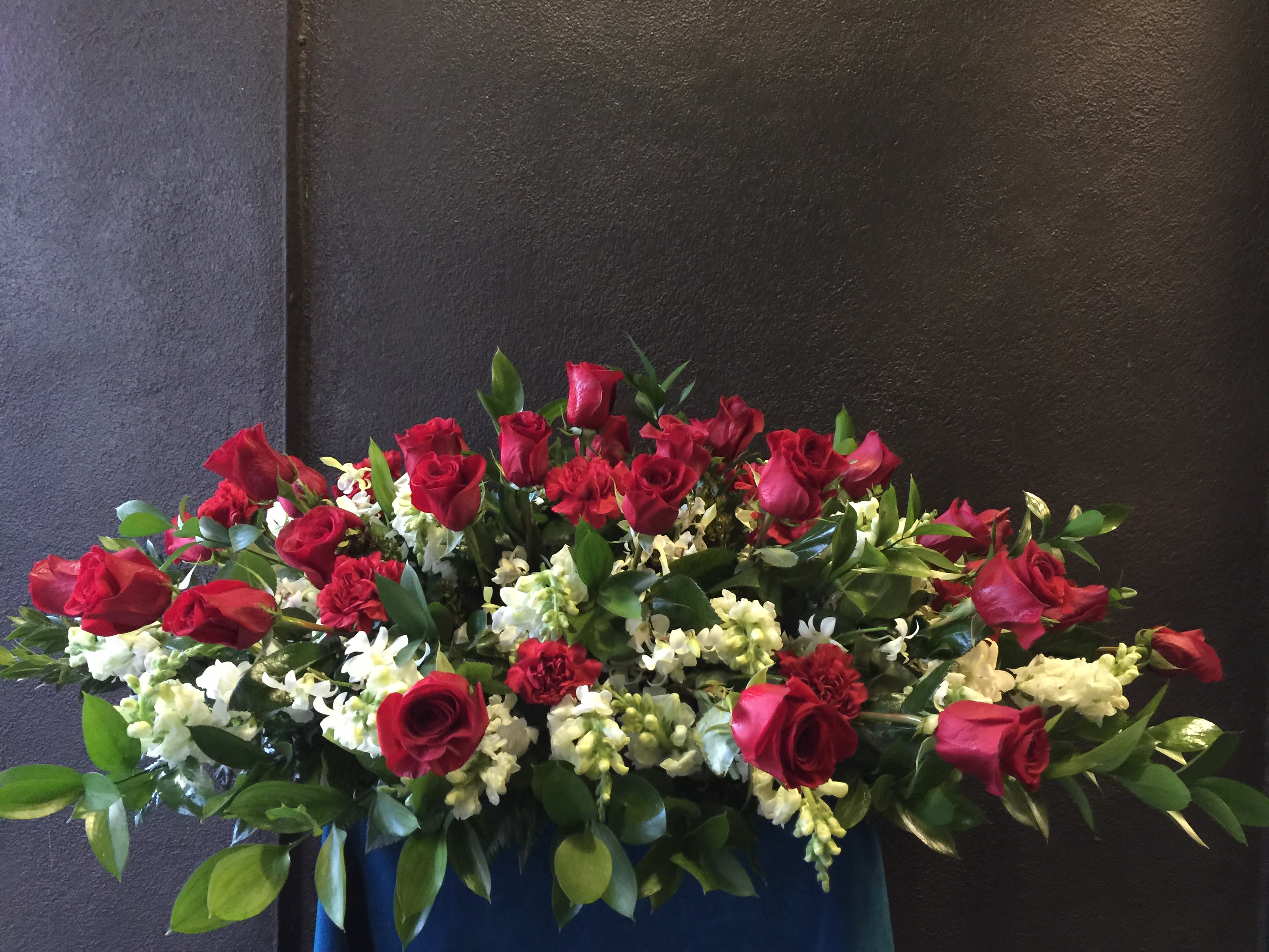 Casket arrangement red and white - Strong contrast and impact of red roses and carnations intermingled with white  snapdragon