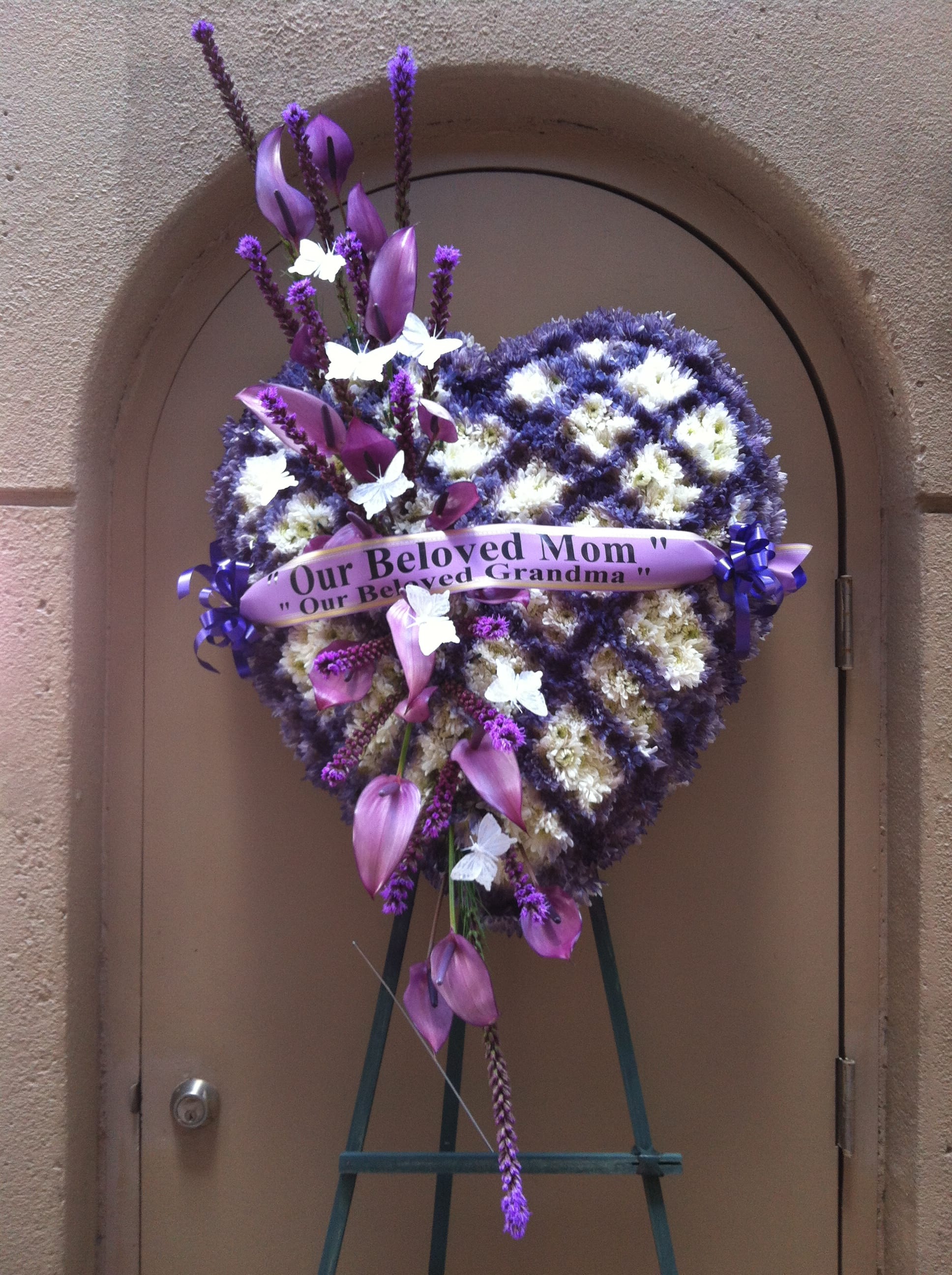 Heart shape purple and white checker mums wreath - F35011 - Unique heart shape in purple and white mums checker style with  purple Antherium artfully spike across heart, and white butterflies fluttered all over for a beautiful send off.