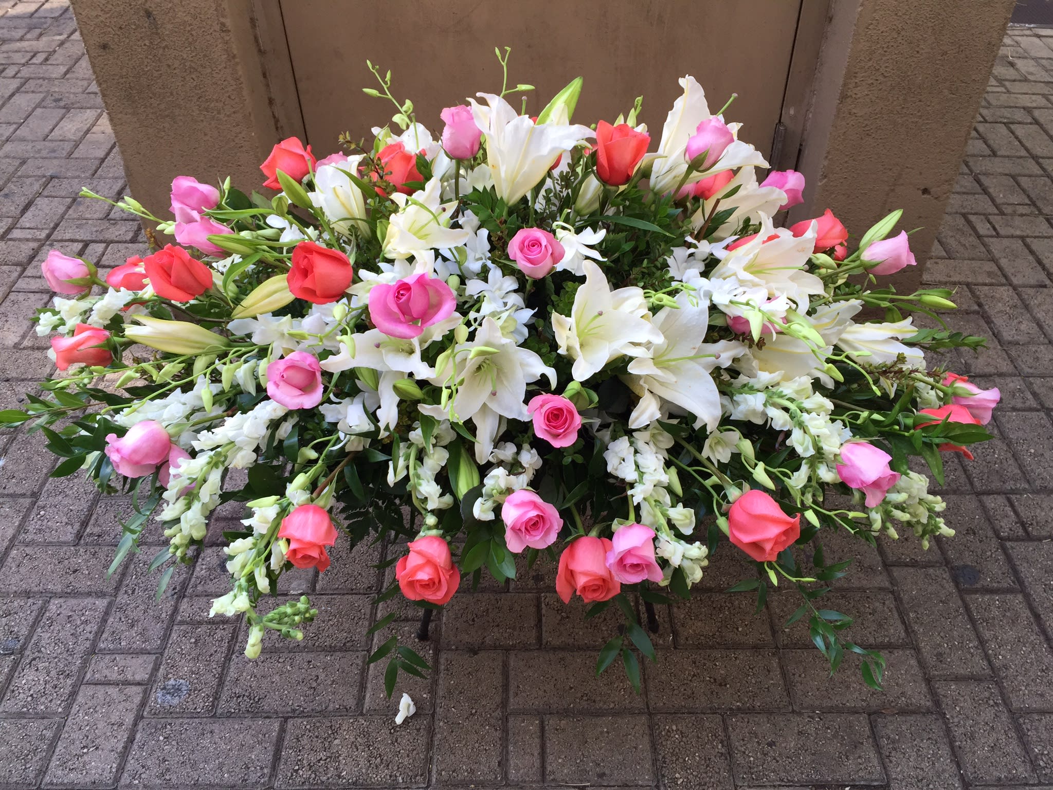 Spring floral Casket - Soft spring colorful sprays of roses, lilies and orchids 