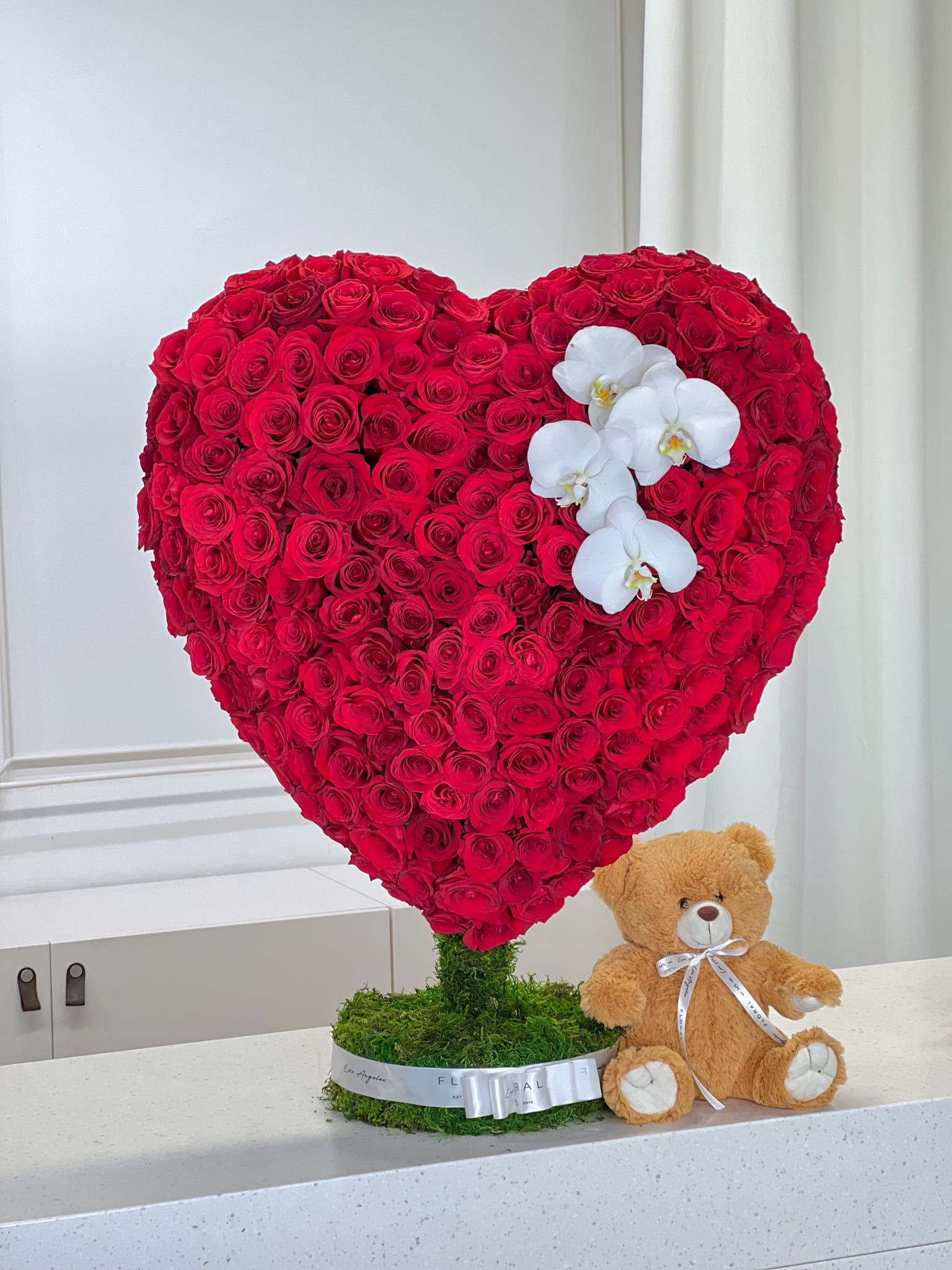 No.136 LOVE IS No.136 LOVE IS - Expertly arranged by our skilled florist in Studio City, this heart statue of classic roses offers a modern twist on a timeless gesture. Elegant and refined, it's the perfect gift for any occasion. With same day flower delivery available, sending a stunning floral surprise has never been easier. Experience the beauty and sophistication of a luxurious rose presentation. Approximately 175-200 roses
