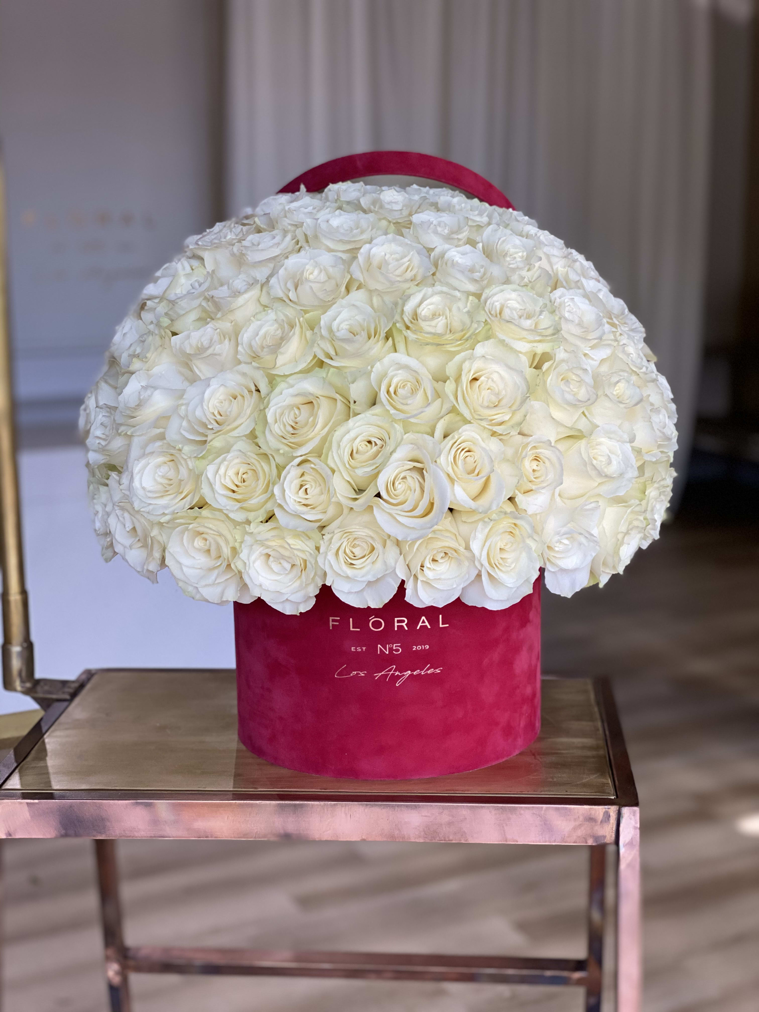 No.143-White Roses No.143-White Roses - Expertly arranged by our skilled florist in Studio City, this box of classic white roses offers a modern twist on a timeless gesture. Elegant and refined, it's the perfect gift for any occasion. With same day flower delivery available, sending a stunning floral surprise has never been easier. Experience the beauty and sophistication of a luxurious rose presentation. Available in three size options and diverse box textures and colors. Standard size - 50 roses. Deluxe size - 75 roses. Premium size - 125 roses. On the photo: Size - Deluxe, Box Material - Velvet, Box Color - Burgundy.