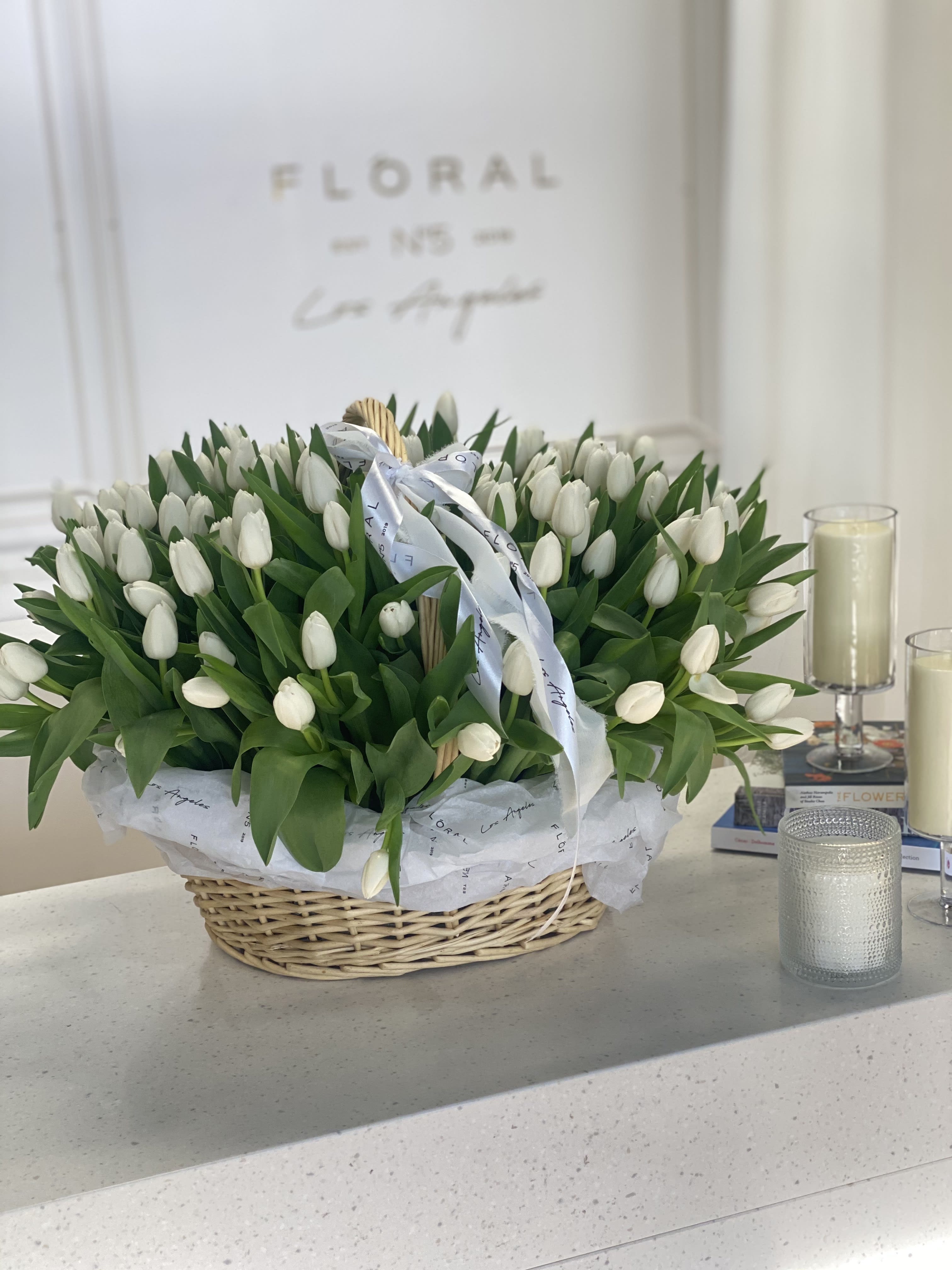 No.147 - AMAZING GIANT BASKET WITH WHITE TULIPS No.147 - AMAZING GIANT BASKET WITH WHITE TULIPS - A modern take on floral gifting, this flower basket of fresh white tulips is a curated blend of seasonal blooms and textures, thoughtfully designed in Studio City. Each basket is a unique expression of beauty and emotion—perfect for making a lasting impression. Whether it’s a celebration or a simple gesture of love, our same day flower delivery ensures your heartfelt gift arrives fresh, elegant, and right on time. Available in two sizes - 150 tulips and 300 tulips In the picture - Deluxe size (300 tulips)
