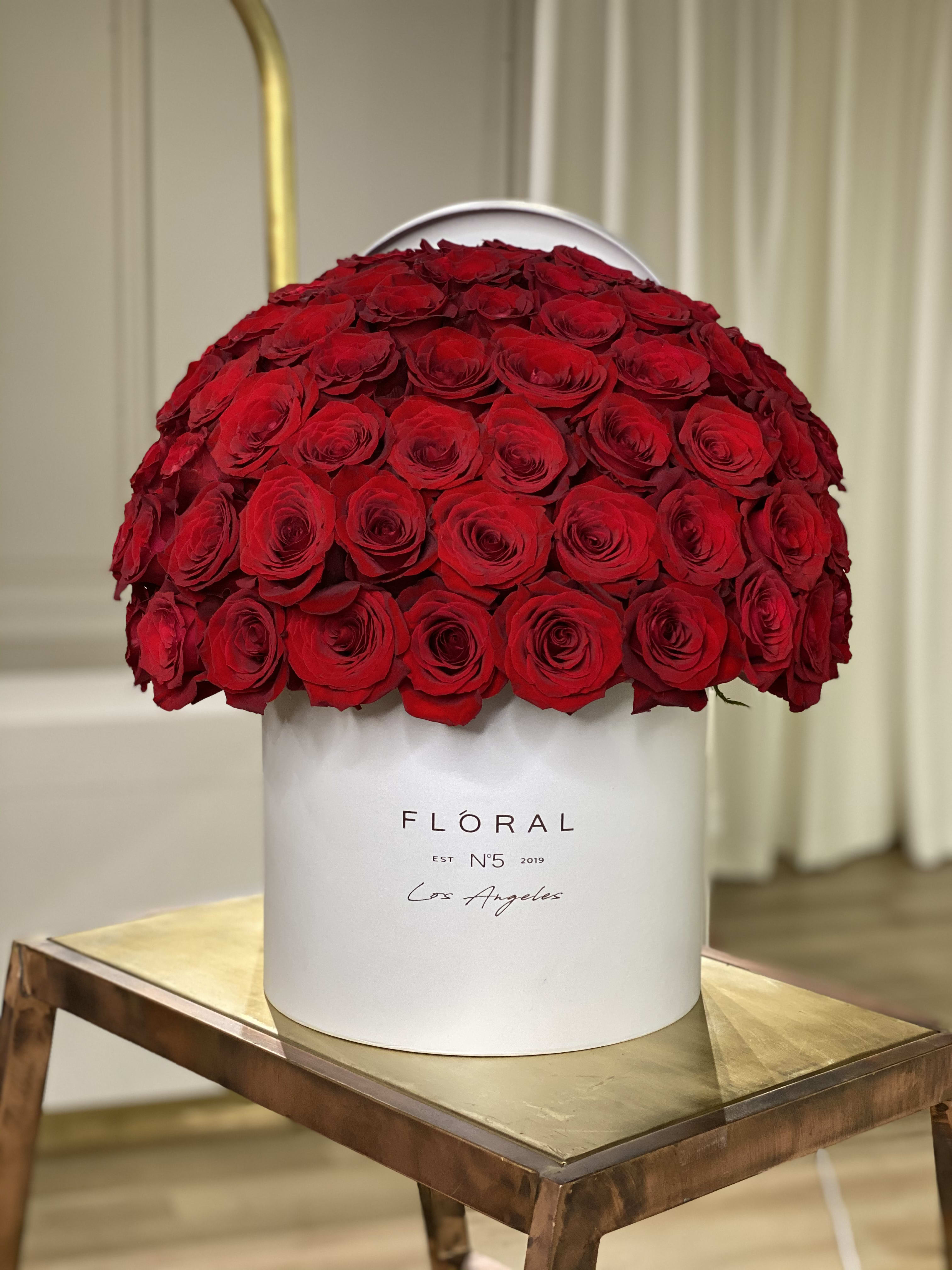 No.163 - Red Roses No.163 - Red Roses - Expertly arranged by our skilled florist in Studio City, this box of classic roses offers a modern twist on a timeless gesture. Elegant and refined, it's the perfect gift for any occasion. With same day flower delivery available, sending a stunning floral surprise has never been easier. Experience the beauty and sophistication of a luxurious rose presentation. Available in three size options and diverse box textures and colors. Standard size - 50 red roses. Deluxe size - 75 red roses. Premium size - 125 red roses. On the photo: Size - Deluxe, Box Material - Paper, Box Color - White.