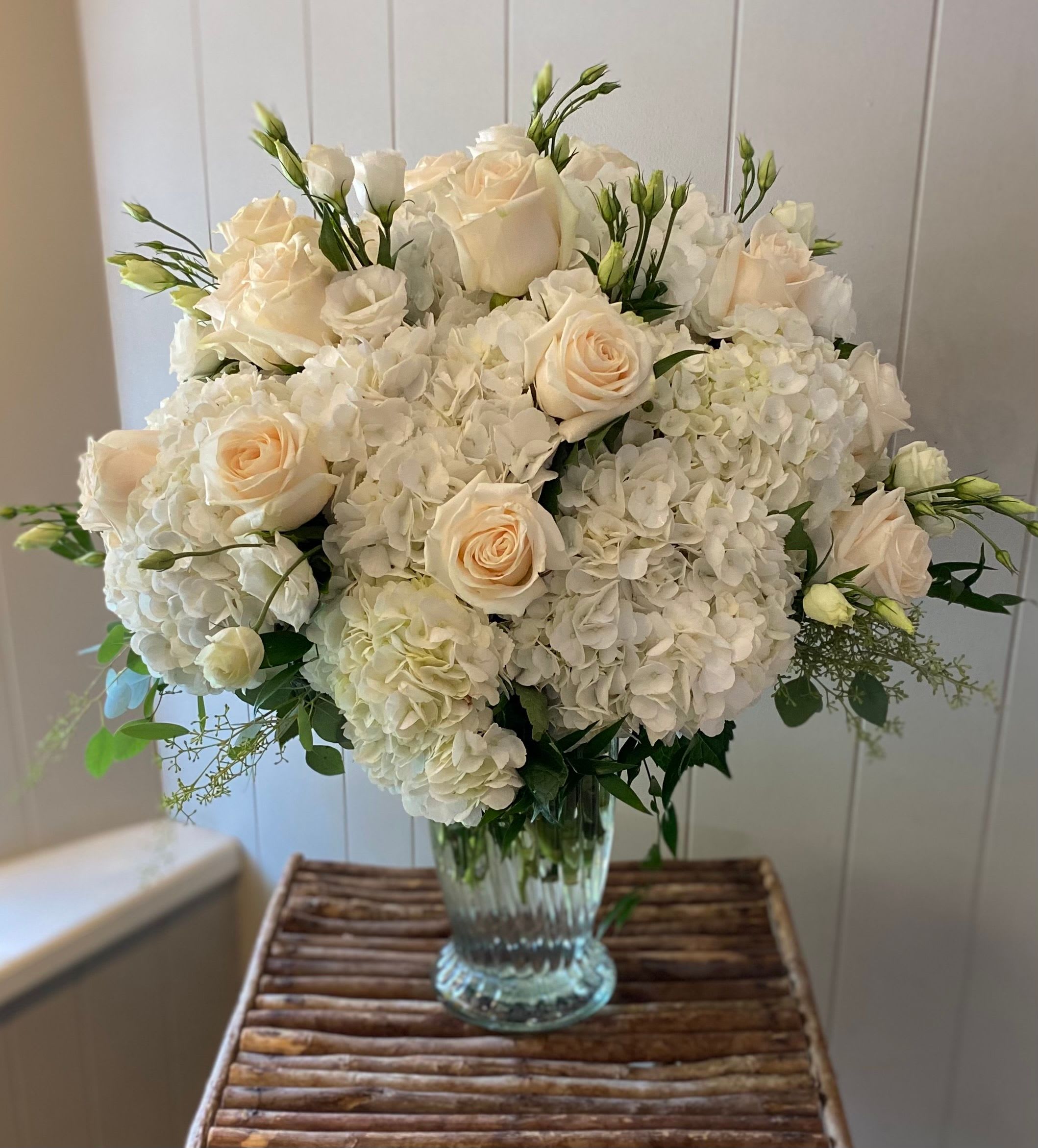 Cloud Nine Cloud Nine - A dreamy arrangement of lush white hydrangea's, ivory roses, and soft seasonal blooms. This timeless arrangement brings sophistication into any space