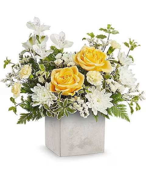 Teleflora's Contemporary Blossoms Bouquet - Bring a touch of modern elegance to their day with the Contemporary Blossoms Bouquet, featuring fresh white and yellow blooms arranged in a sleek concrete-inspired Modern Paradise vase.  The Contemporary Blossoms Bouquet features yellow roses, white alstroemeria, light yellow miniature carnations, white cushion spray chrysanthemums, white sinuata statice, white limonium, leatherleaf fern, and pitta negra. Arranged in the sleek Modern Paradise vase, this bouquet is a bright, stylish gift.