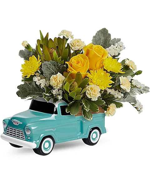 Teleflora's Chevy Blooming Pickup Bouquet - Free-wheeling fun! Make any moment memorable with a radiant rose bouquet, arranged in the back of a hand-glazed ceramic Chevy!  Yellow roses, miniature yellow carnations, yellow cushion spray chrysanthemums, white sinuata statice and green leucadendron are arranged with dusty miller and variegated pittosporum. Delivered in a Chevy Pickup Keepsake.