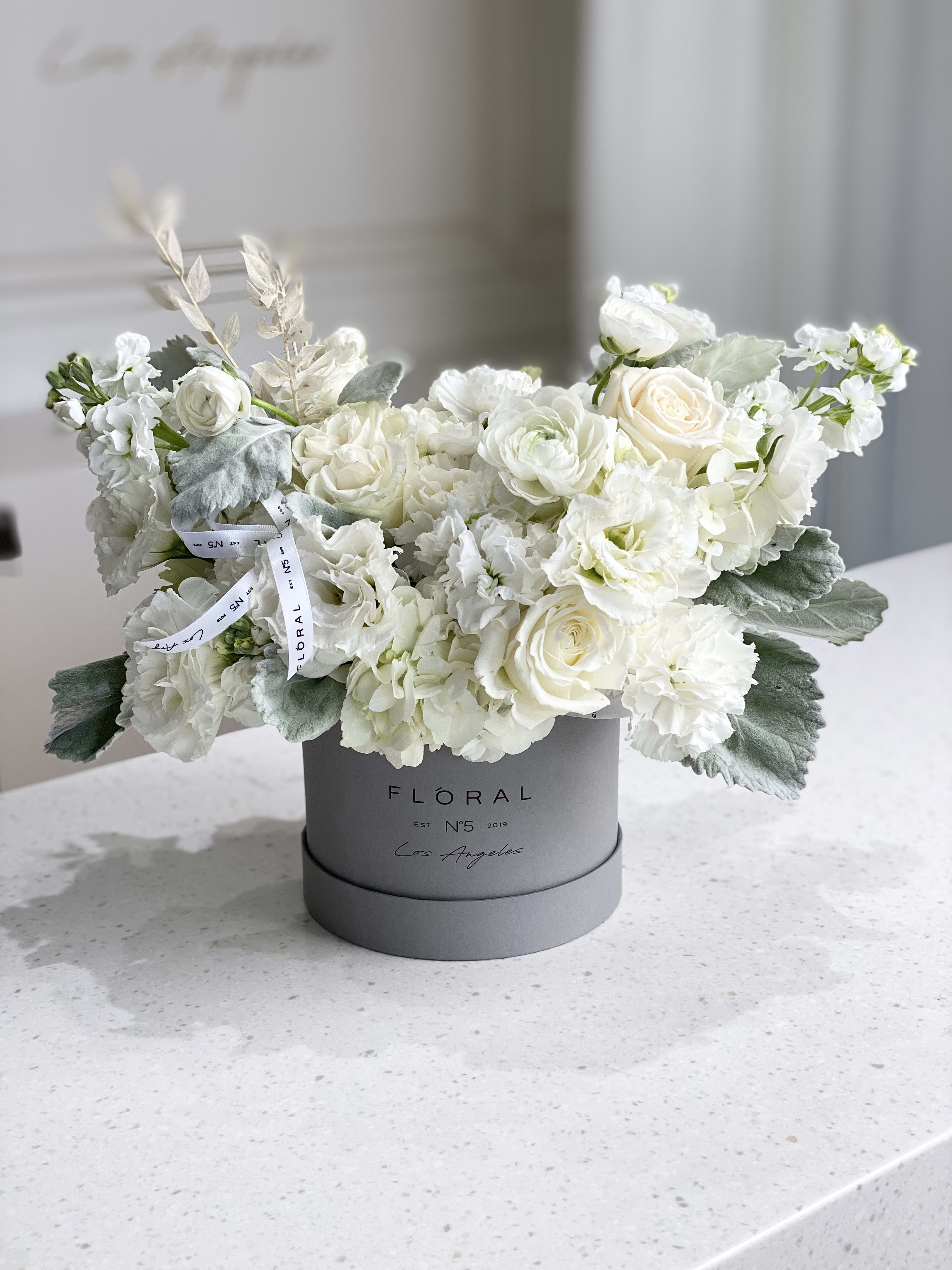 No.238-Lisianthuses, Roses & Matthiolas MD No.238-Lisianthuses, Roses & Matthiolas MD - A modern take on floral gifting, this mixed flower box is a curated blend of seasonal blooms and textures, thoughtfully designed in Studio City. Each box is a unique expression of beauty and emotion—perfect for making a lasting impression. Whether it’s a celebration or a simple gesture of love, our same day flower delivery ensures your heartfelt gift arrives fresh, elegant, and right on time. A tender flower composition of Lisianthuses, Roses, Matthiolas and other seasonal flowers to complete the arrangement. Available in three size options and diverse box textures and colors. On the photo: Size - Standard, Box Material - Paper, Box Color - Grey.