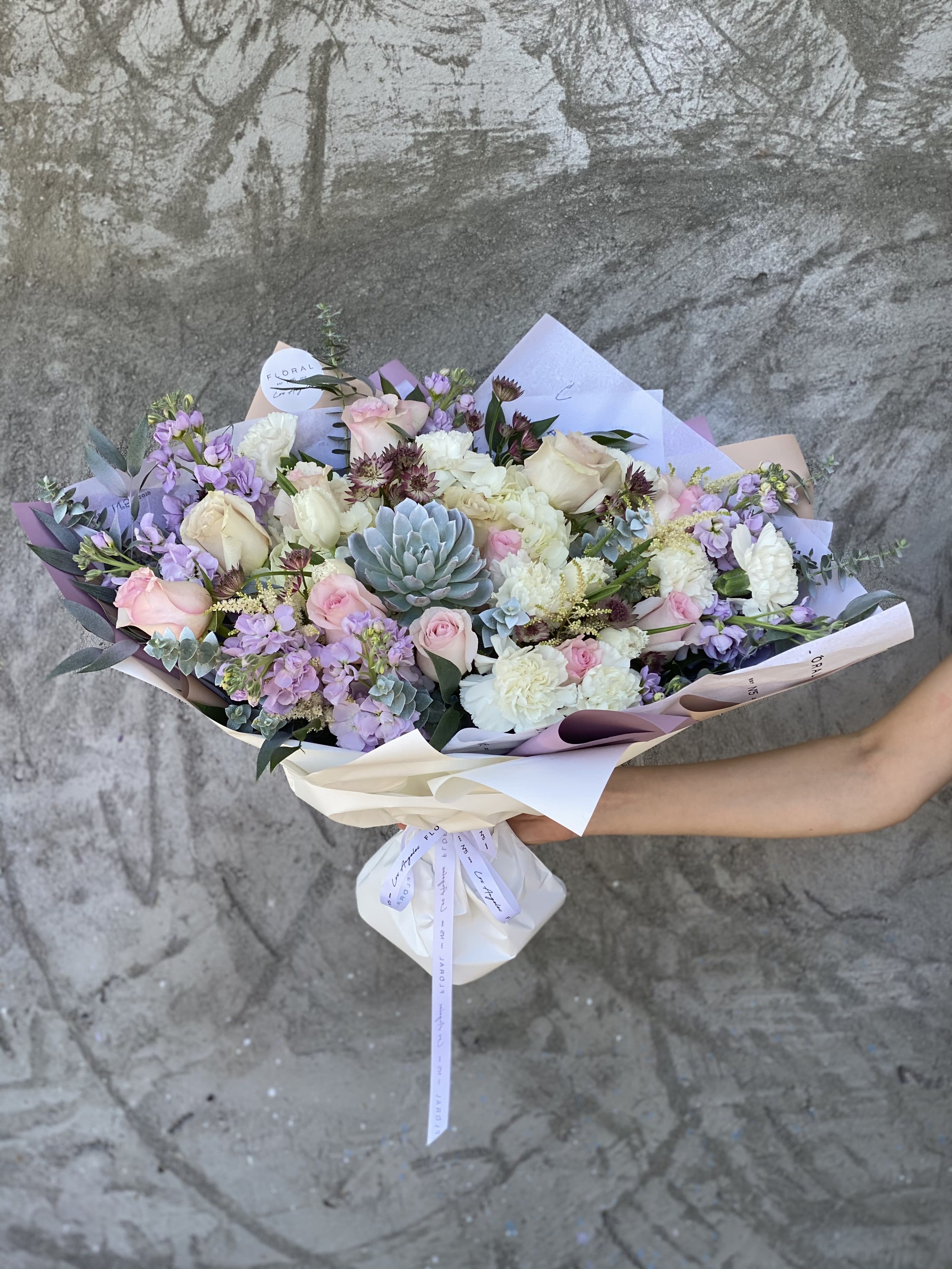 NO.30 - MIXED BOUQUET IN VIOLET SHADES NO.30 - MIXED BOUQUET IN VIOLET SHADES - This mixed flower bouquet in violet shades is a heartfelt expression of life’s most meaningful moments—crafted with care by our dedicated florist in Studio City. Each stem is thoughtfully selected to create a vibrant blend of color, fragrance, and feeling. More than just flowers, it's a gesture that speaks volumes. With same day flower delivery, your sentiment arrives right on time, beautifully delivered and impossible to forget. Mixed bouquet is made with roses, matthiolas, carnations and other flowers to complete the composition. Available in three size options. Size on photo: Size - Deluxe.