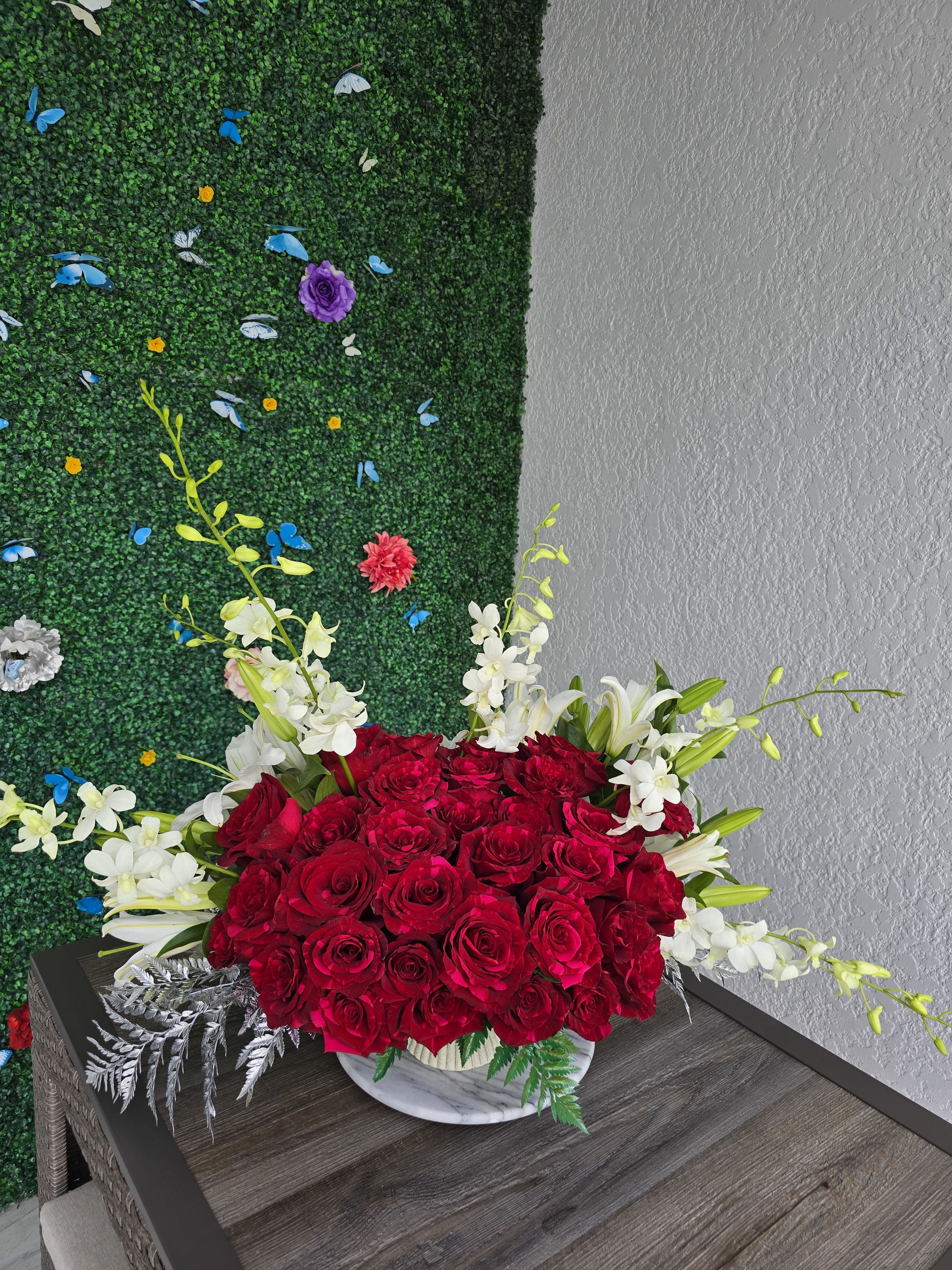ELEGANT CENTERPIECE - Elegant Floral Centerpiece – Perfect for Hallways &amp; Refined Spaces  Add a touch of timeless elegance to your hallway or entry space with our handcrafted floral centerpieces. Designed to complement refined interiors, each arrangement features premium blooms thoughtfully selected for their beauty, texture, and harmony.  Whether placed on a console, hallway table, or as part of a decorative accent wall, this piece brings warmth, sophistication, and natural charm to your home or office.  Created in a low, balanced design to suit narrow spaces without overwhelming them — elegance in every detail. ️   Delivery available  Graceful. Modern. Made to welcome with style