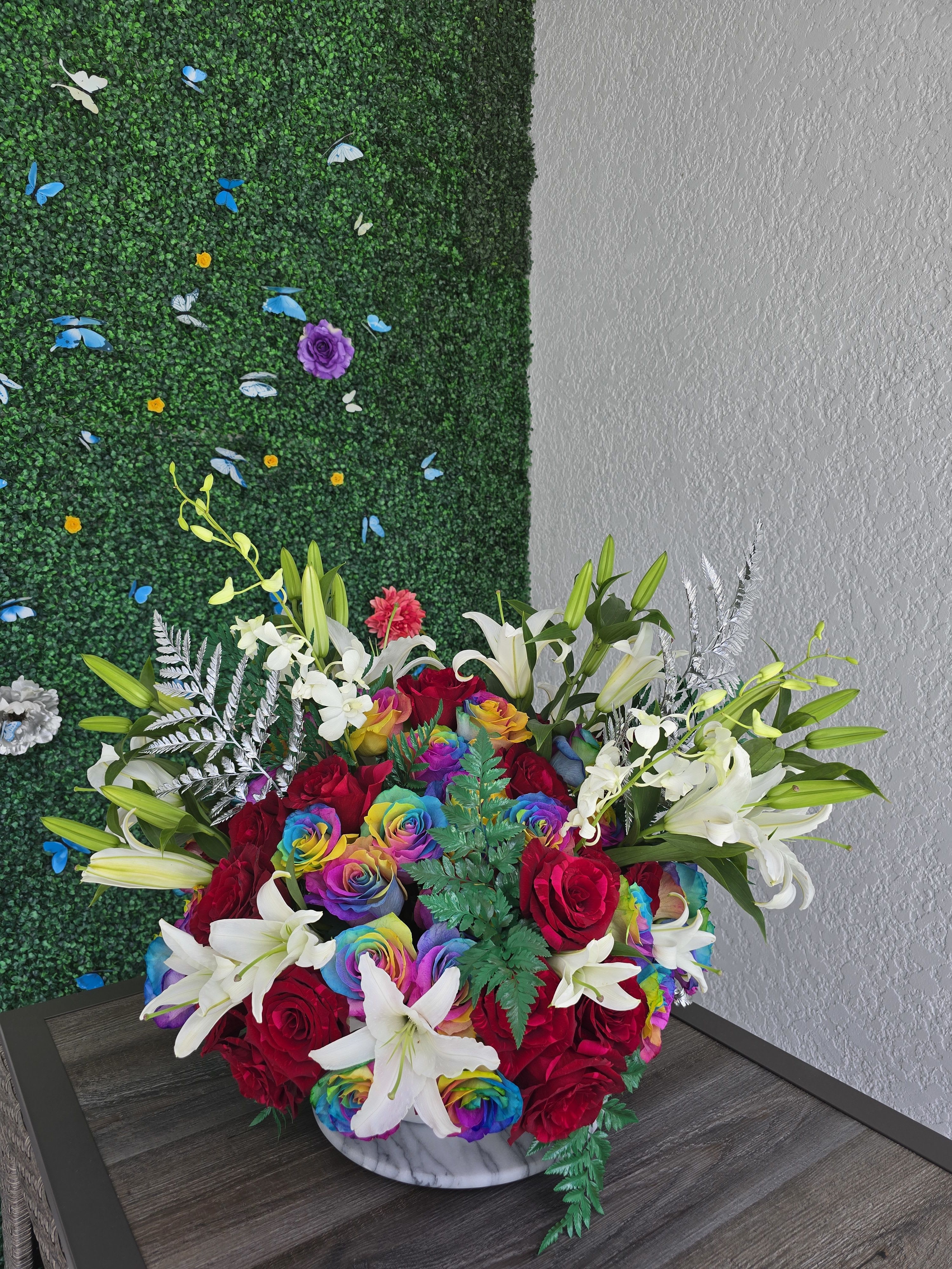 Multicolor Rose Arrangement -   – A Unique Floral Experience  Vibrant, joyful, and truly one of a kind — our multicolor rose arrangement is a celebration of color and creativity. Featuring roses in a stunning mix of hues, this design goes beyond the ordinary to deliver something bold, cheerful, and unforgettable.  Each rose is carefully selected to create a harmonious yet playful palette that symbolizes diversity, energy, and emotion. Perfect for someone who loves originality, or for moments when you want your gift to stand out in every way.   Delivery available  One bouquet. Endless color. Totally unique.