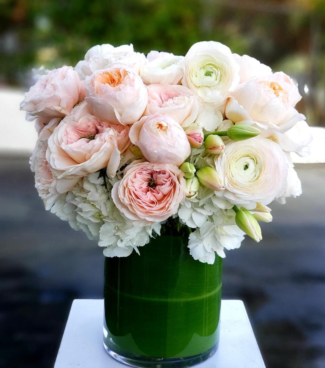 Bel Air Blossoming Angels - Express your deepest emotions with the breathtaking beauty of a Ranunculus, Tulip, and Hydrangea bouquet from Dave's Flowers, your trusted local florist in Los Angeles. This captivating combination embodies tenderness, love, and spring's joyful awakening, guaranteeing to make anyone blush with delight.  Soft and Fragrant Ranunculus: Boasting gentle, ruffled petals in a range of soft pastel colors, Ranunculus add a touch of romance and innocent charm to the bouquet. Blooming Tulips: Bursting with vibrant colors, blooming tulips symbolize springtime and renewal. They add a touch of playful joy and optimism to the arrangement, reflecting the happiness and excitement of love. Airy Hydrangeas:  Locally Sourced Freshness: Dave's Flowers uses only the highest-quality blooms, sourced fresh from local growers. Your bouquet will arrive bursting with vibrant colors and delicate fragrance, ready to express your love with the freshest beauty. Expertly Arranged: Our skilled Los Angeles florists handcraft each bouquet with meticulous attention to detail. The harmonious blend of colors, textures, and shapes creates a visually stunning and emotionally evocative masterpiece.  Visit Dave's Flowers online or in-store in Los Angeles to experience the beauty and emotion of this breathtaking bouquet. We offer convenient flower delivery in Los Angeles to ensure your floral expression arrives fresh and ready to convey your heartfelt love.
