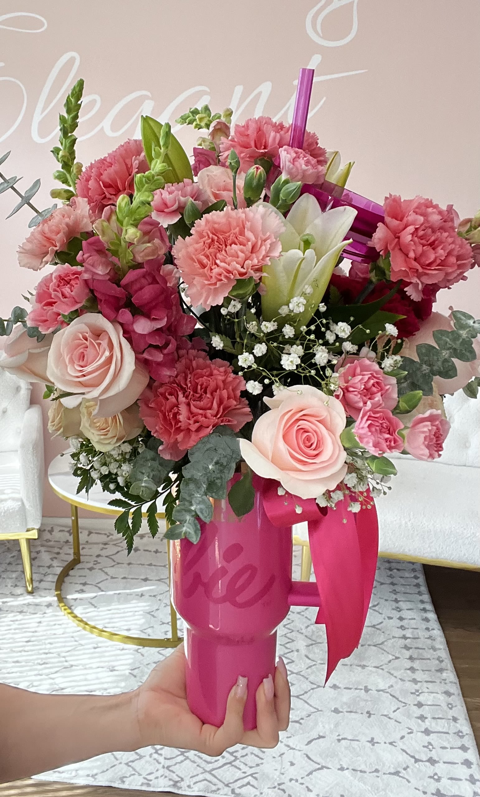  Barbie Stanley Cup - Step into a world of glam and florals with our Barbie Stanley Cup — the ultimate pink dream for flower lovers and fashionistas alike! Arranged inside a trendy pink Stanley Cup-inspired tumbler, this fabulous bouquet features a blend of pink roses, playful carnations, delicate mini roses, soft eucalyptus, and lush greenery. Every detail is thoughtfully styled to channel that bold, confident Barbie vibe—fun, flirty, and unapologetically pretty! Whether you're celebrating a birthday, a girls' night, a bachelorette party, or just adding a little sparkle to your day, this arrangement is as functional as it is fabulous. And yes, the cup is reusable—so the Barbie magic keeps going long after the flowers are gone!