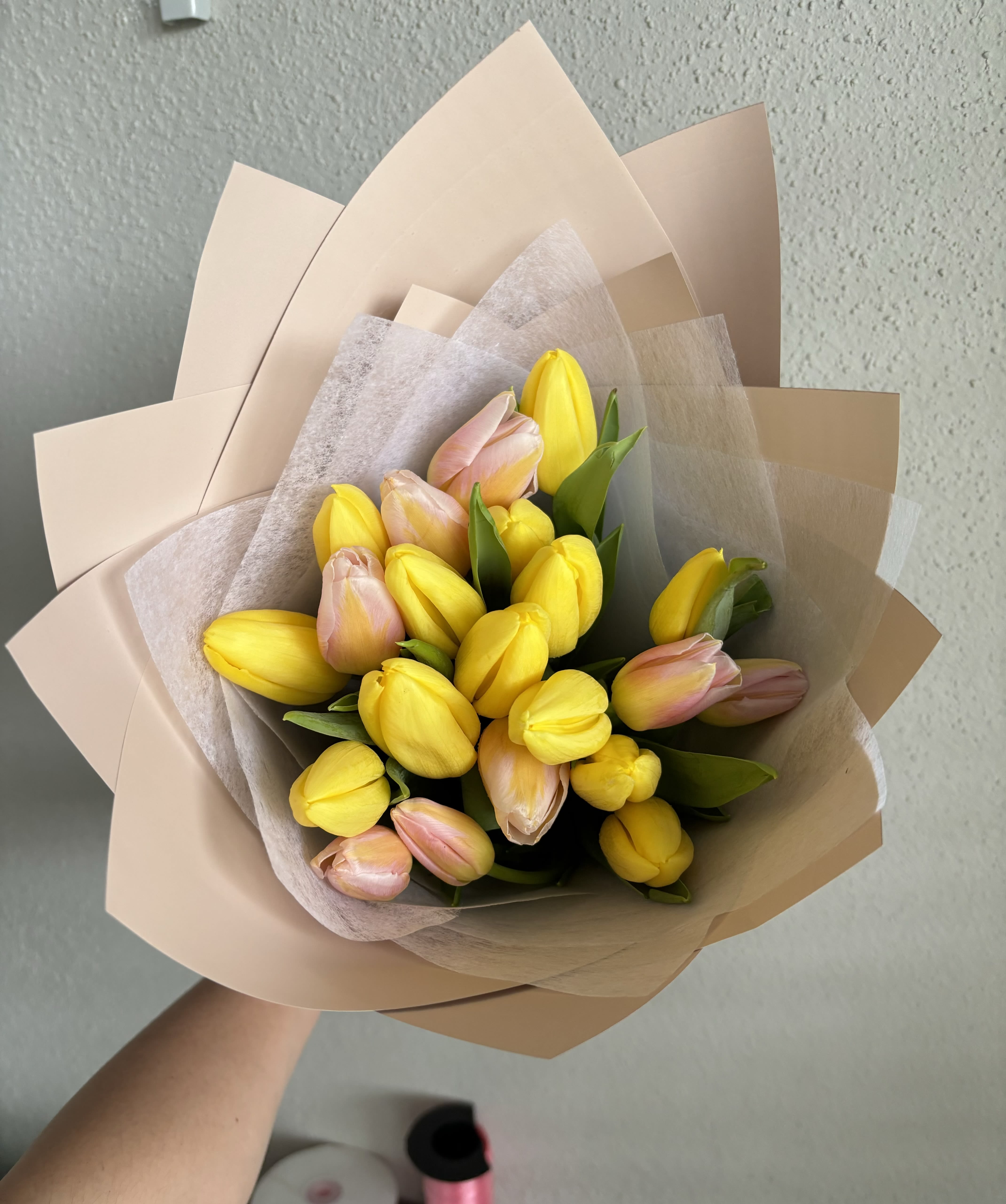 Tulip Wrap Bouquet – Designer’s Choice - A cheerful and modern bouquet featuring fresh tulips in a mix of soft peach and vibrant yellow tones, carefully wrapped in neutral-toned paper for a sophisticated finish. Tulip and wrapping colors are designer’s choice, making each bouquet one-of-a-kind. Perfect for any occasion where you want to make someone smile.