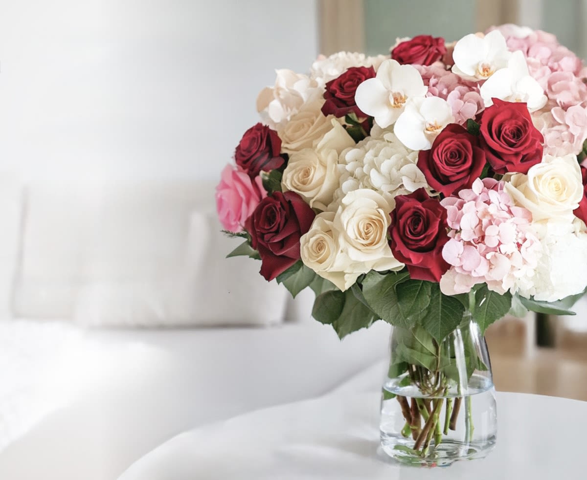 Lux Designer’s Choice - This arrangement includes Orchids, Roses, Hydrangeas only.  Colors will vary.   Call us for questions at 901.618.2661