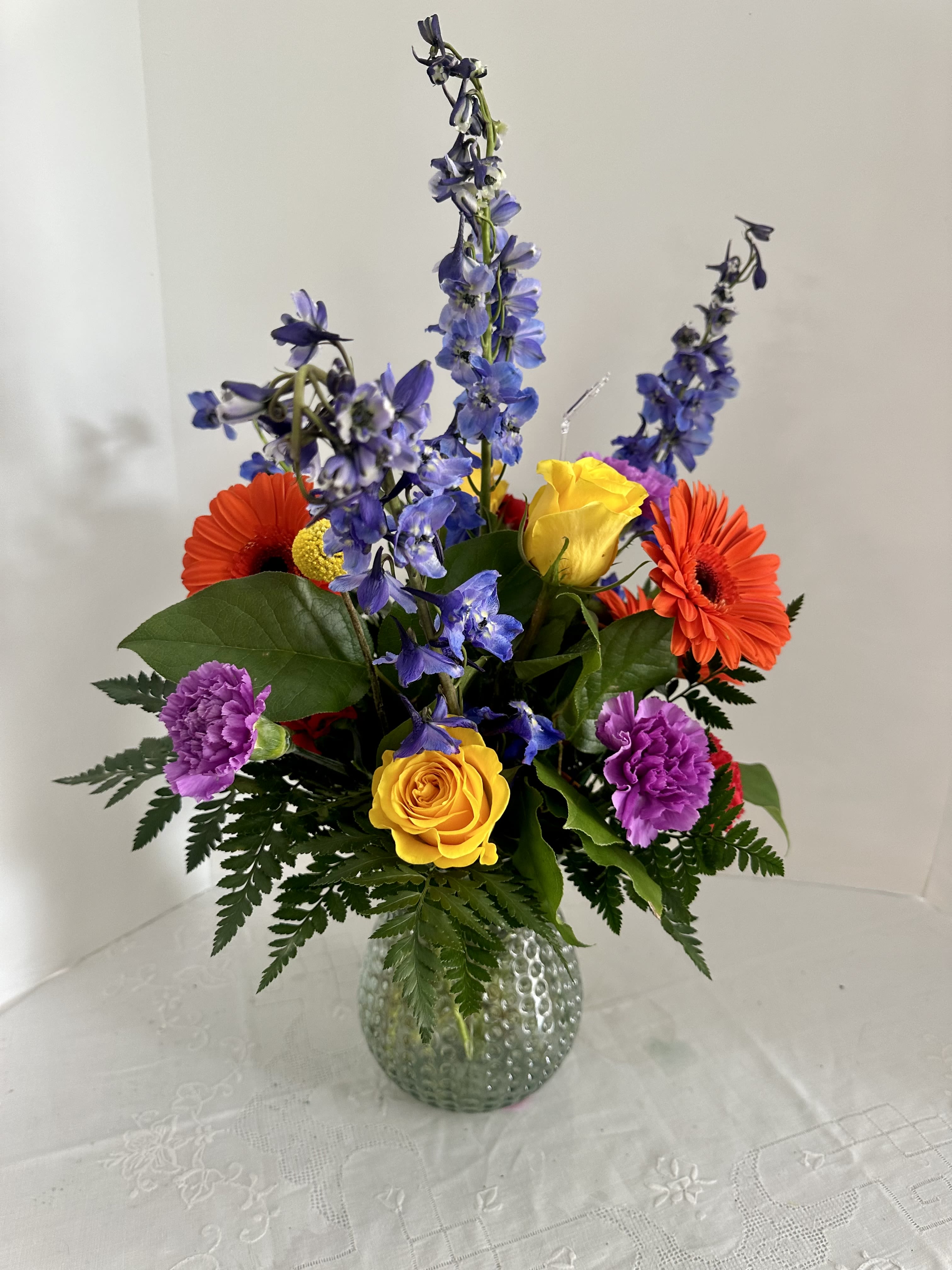 A Vase of Joy! A Vase of Joy! - This arrangement is perfect to make someone's day! Created with bright gerbera daisies, delphinium, roses, and carnations.