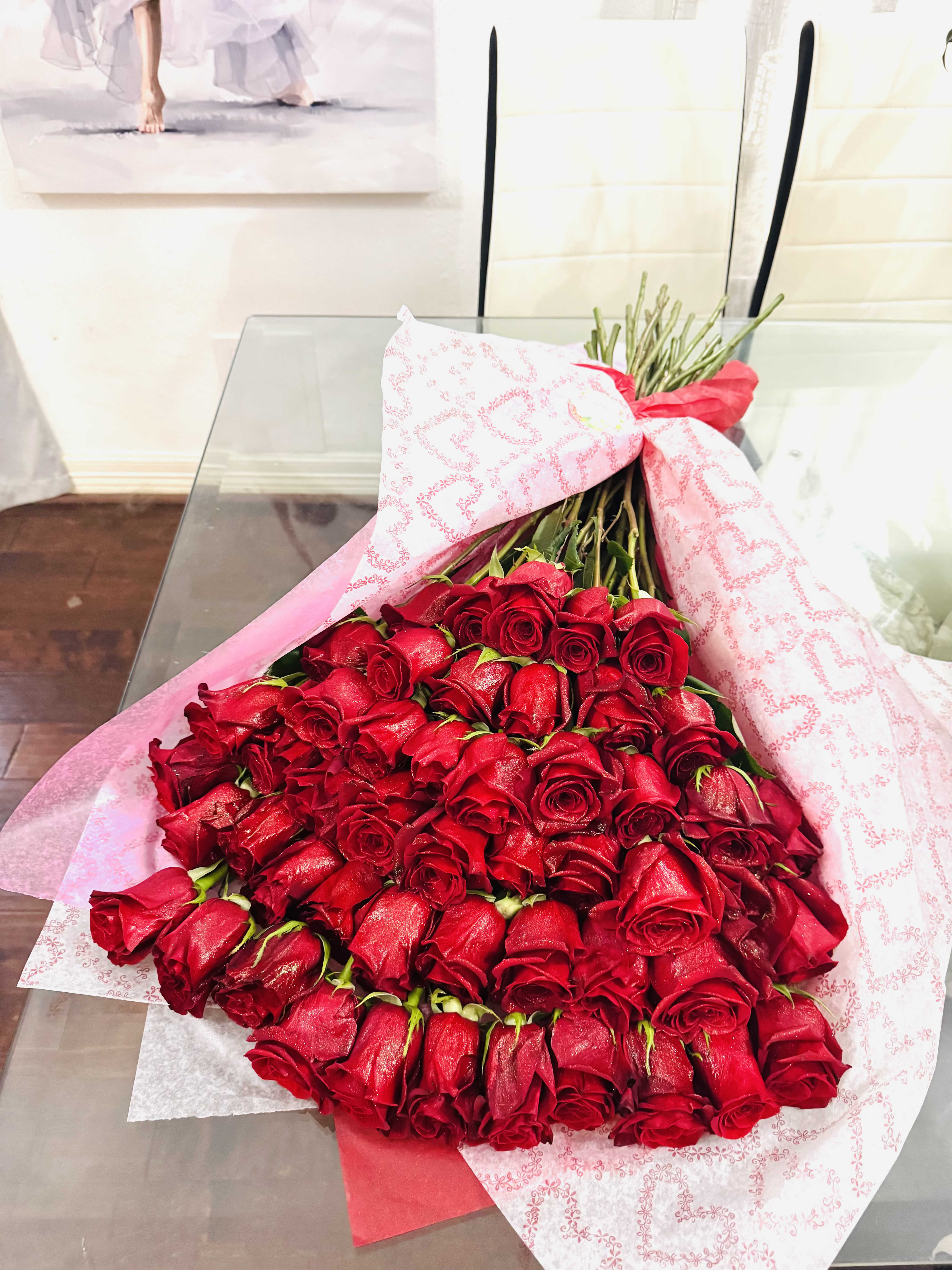 Red Wrapped roses - Nothing says love like roses. Show your sweetheart they’re the one with a luxurious gift that will sweep them off their feet. Red roses are the timeless language of passion- a bold, elegant expression of love that needs no translation. Each bloom unfurls like velvet, its deep crimson petals rich with emotion and intensity. Their fragrance is subtle yet intoxicating, like a whispered secret held close to the heart.     More than just flowers, red roses are living poetry- symbols of desire, devotion, and enduring romance. In a bouquet or on their own, they command attention not with flash, but with the kind of beauty that's both classic and unforgettable. Their elegance lies in their simplicity: no embellishment needed, no excess- just pure, powerful grace.  1 Dozen- Standard Bouquet 2 Dozen- Deluxe Bouquet 3 Dozen- Premium Bouquet