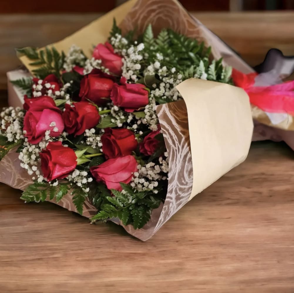 Love Roses Wrapped - This bouquet is a romantic and classic hand-tied arrangement, with deep red roses, symbolizing love and passion, baby's breath, adding a delicate, airy charm, greenery for fullness and contrast, and wrapped in elegant water proof paper.  The combination suggests timeless elegance, ideal for romantic gestures or meaningful celebration. 1 Dozen- 12 Roses 2 Dozen- 24 Roses 3 Dozen- 36 Roses