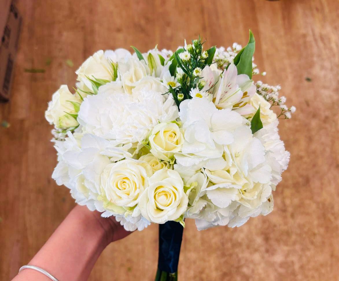 Classic White Handheld Bouquet - White classic white bouquet with assorted fresh flowers and green filler, tied with ribbon. The perfect accessory for any formal event including proms, weddings, etc.
