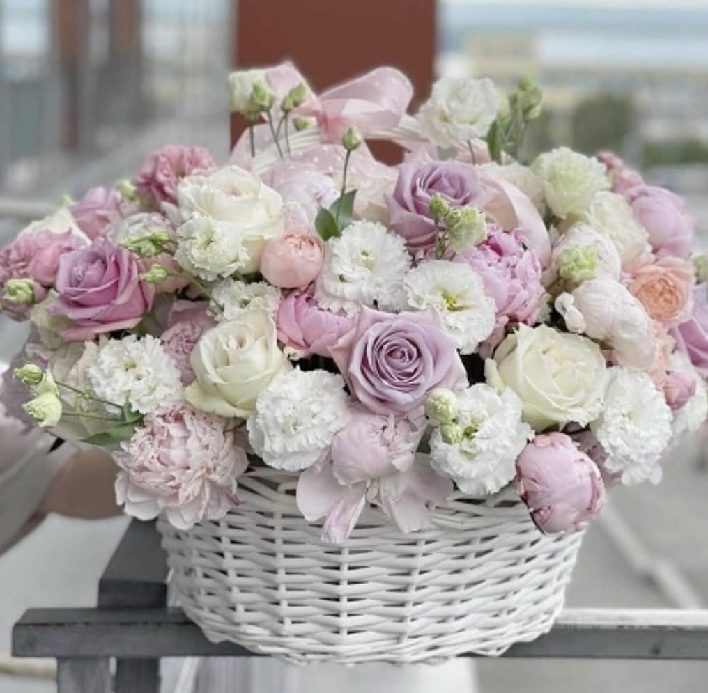Blush Basket Garden - Blush Basket Garden — a dreamy floral arrangement featuring soft pastel roses, white carnations, pale pink peonies, and lisianthus, all carefully arranged in an elegant white wicker basket. This luxurious bouquet exudes grace and timeless beauty, making it ideal for birthdays, baby showers, bridal gifts, or heartfelt “thinking of you” gestures.  Crafted by expert florists at Hollywood Blooms, this arrangement embodies refined charm and delicate femininity. It’s the perfect choice for anyone searching for luxury flower delivery Los Angeles, pastel flower basket, or a Hollywood florist offering elegant same day flower delivery.  Surprise your loved ones with a soft and stylish floral gift that speaks volumes without saying a word.