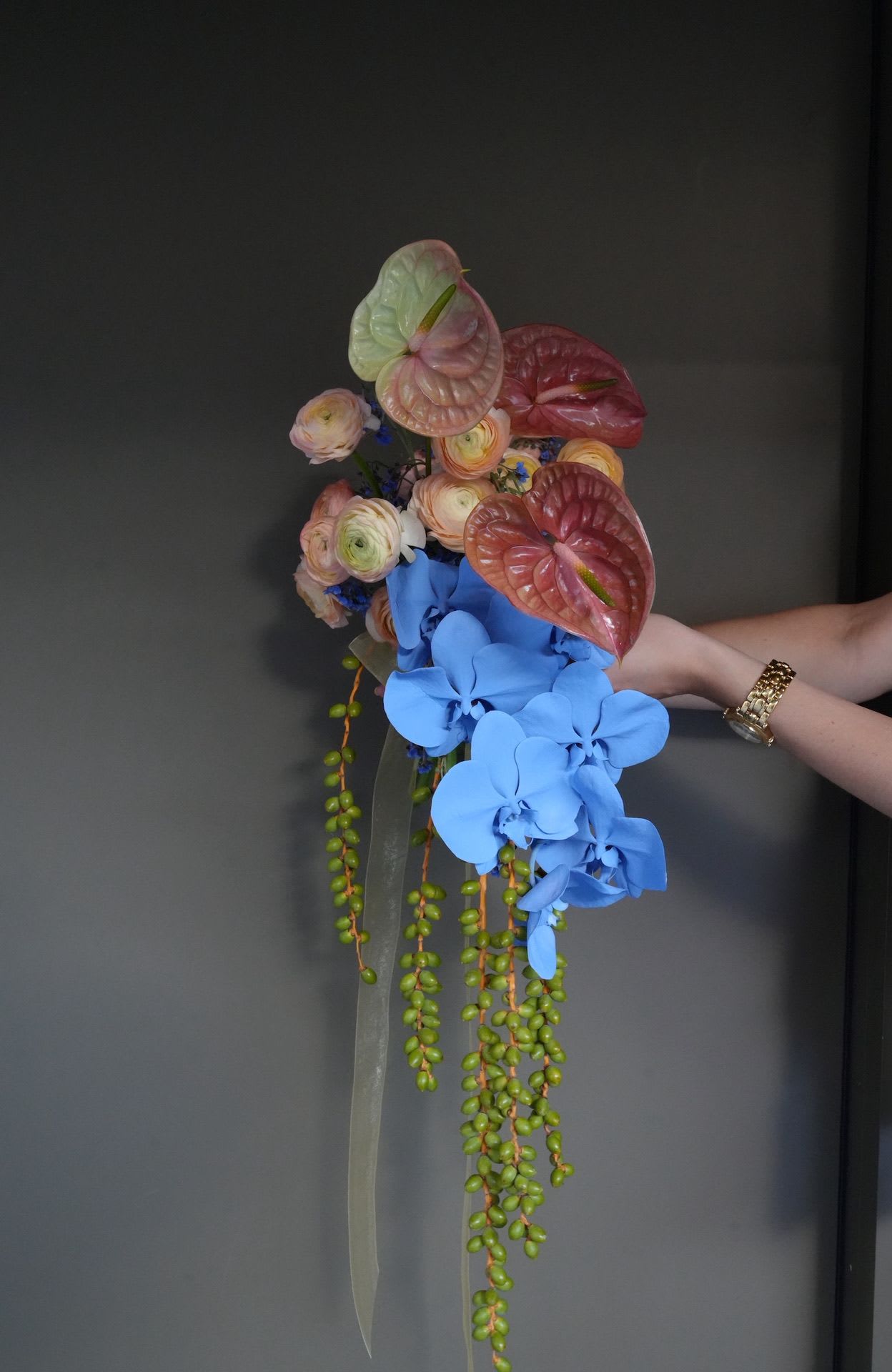 Orchid Runway - A sculptural bouquet that blurs the line between floristry and fashion.   This bouquet is made with high-end seasonal and tropical flowers. Some elements may vary depending on availability, while the overall silhouette and dramatic impact remain the same. If you’d like to confirm or adjust specific flowers, feel free to consult with our florist prior to ordering.