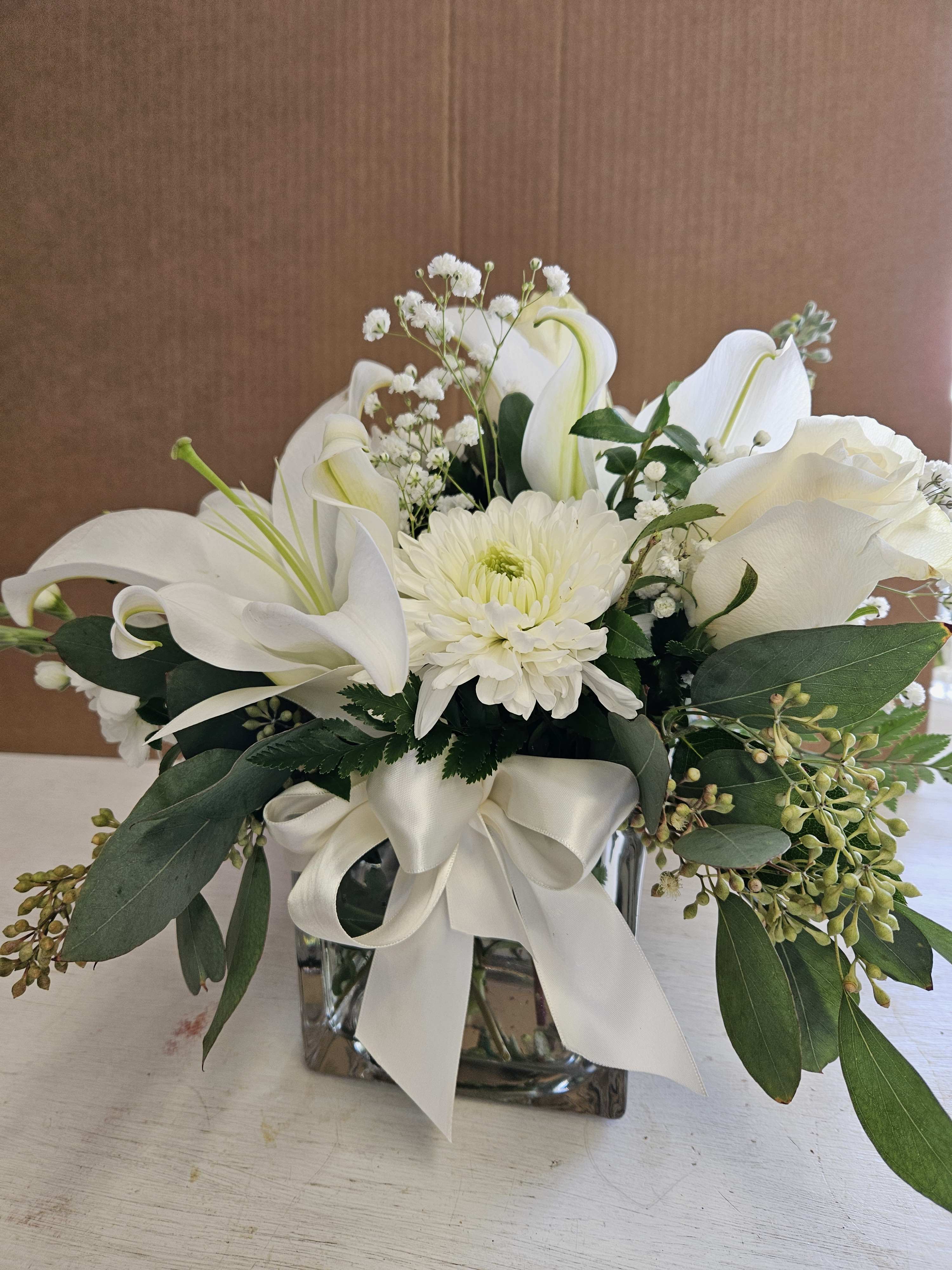 White cube of flowers White cube of flowers - Clear glass cube of mixed white flowers!