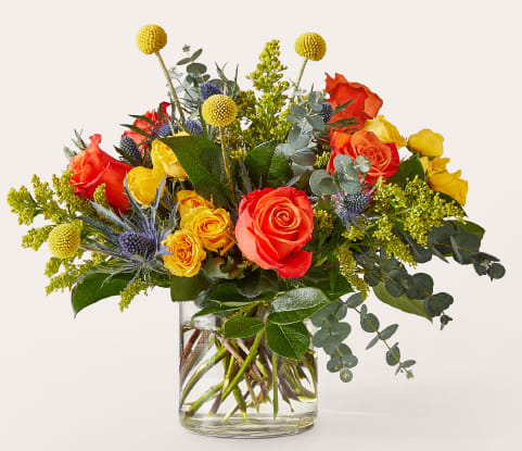 Disco Bouquet - Disco Bouquet dazzles with vibrant Orange Roses, Yellow Spray Roses, and wild Thistle Eryngium, accented by playful Solidago and rustic Eucalyptus.   Packed in a modern glass vase, this bold arrangement is perfect for celebrations, housewarmings, or bringing retro-inspired joy to any space.   Approximately 12&quot;H x 14&quot;W. Order now for fresh flower delivery!