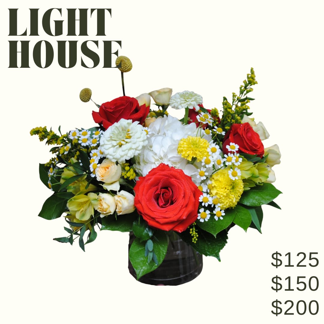 Lighthouse Bouquet - Lighthouse is a low and lush bouquet artfully designed in a clear glass vase using red white &amp; yellow blooms!   *Image shown is valued at $125 *The $150 and $200 price points will be made fuller and more luxurious by adding additional blooms in the same color palette  