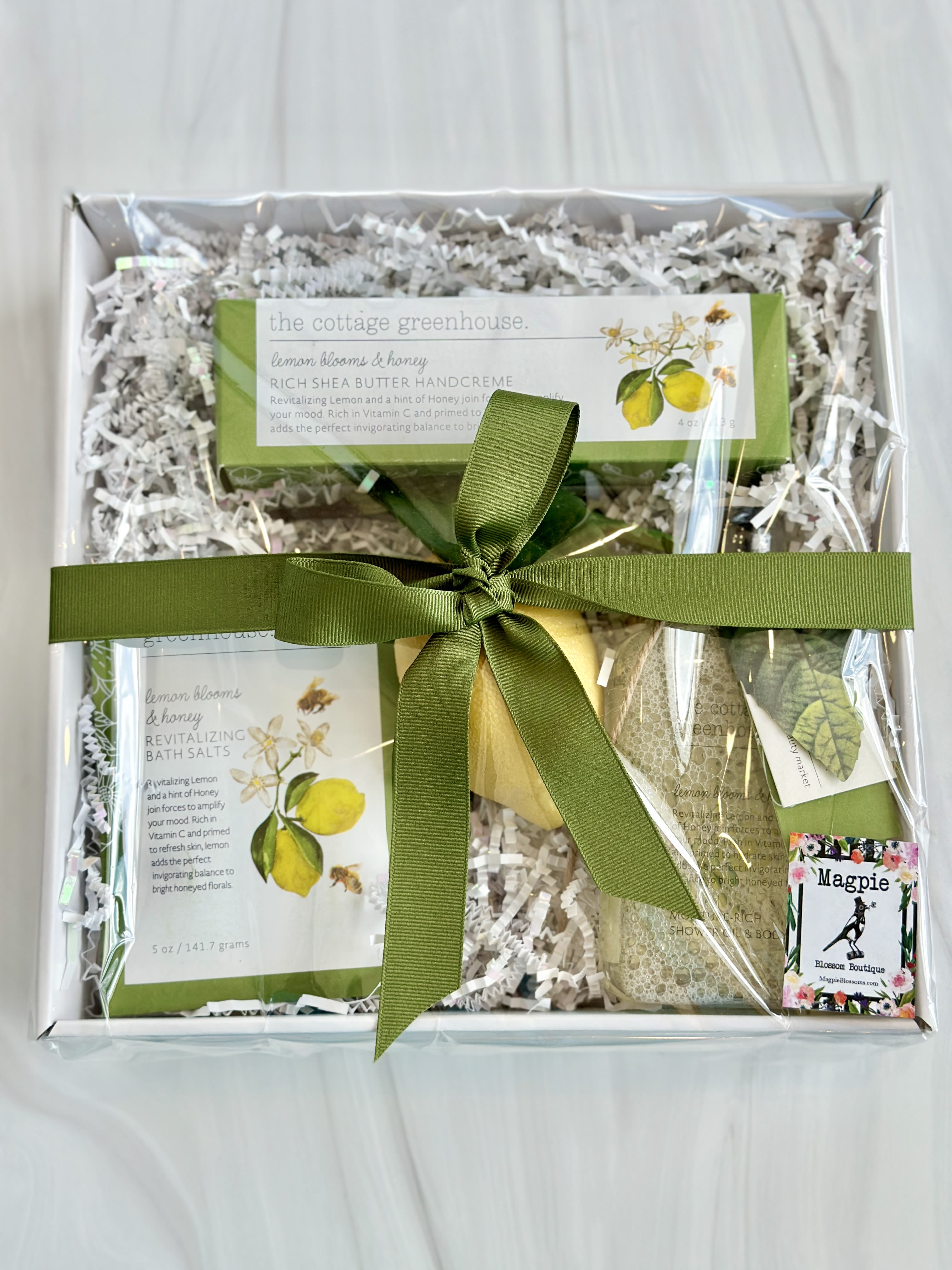 Lemon Blooms &amp; Honey Gift Box - Revitalizing Lemon and a hint of Honey join forces to amplify your mood. Rich in Vitamin C and primed to hydrate skin, lemon adds the perfect invigorating balance to bright honeyed florals. This gift box includes  -A 4oz tube of Lemon Blooms &amp; Honey Rich Shea Butter Handcreme -An 11.5oz Lemon Blooms &amp; Honey Moisture-Rich Shower Oil &amp; Body Wash -A 5oz packet of Lemon Blooms &amp; Honey Revitalizing Bath Salts  -A faux lemon.  All items are presented in a gift box with shred, cello, &amp; a bow. 