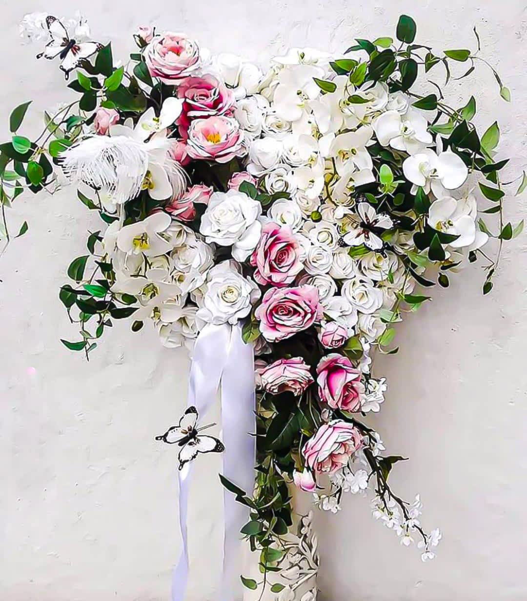 Vanilla And Pink Sympathy Heart Designer's Choice - Designer's choice; made beautifully from my blossom selection of the day. Beautiful vanilla and pink sympathy heart for the service to help honor them in the most loving way with it's beautiful vanilla and pink roses orchids and more arranged in a heart shape. Perfect to help them celebrate a life well lived. All sympathy flower designs are always made extra special and unique each and every time. Please visit my beautiful gallery. Honor them.