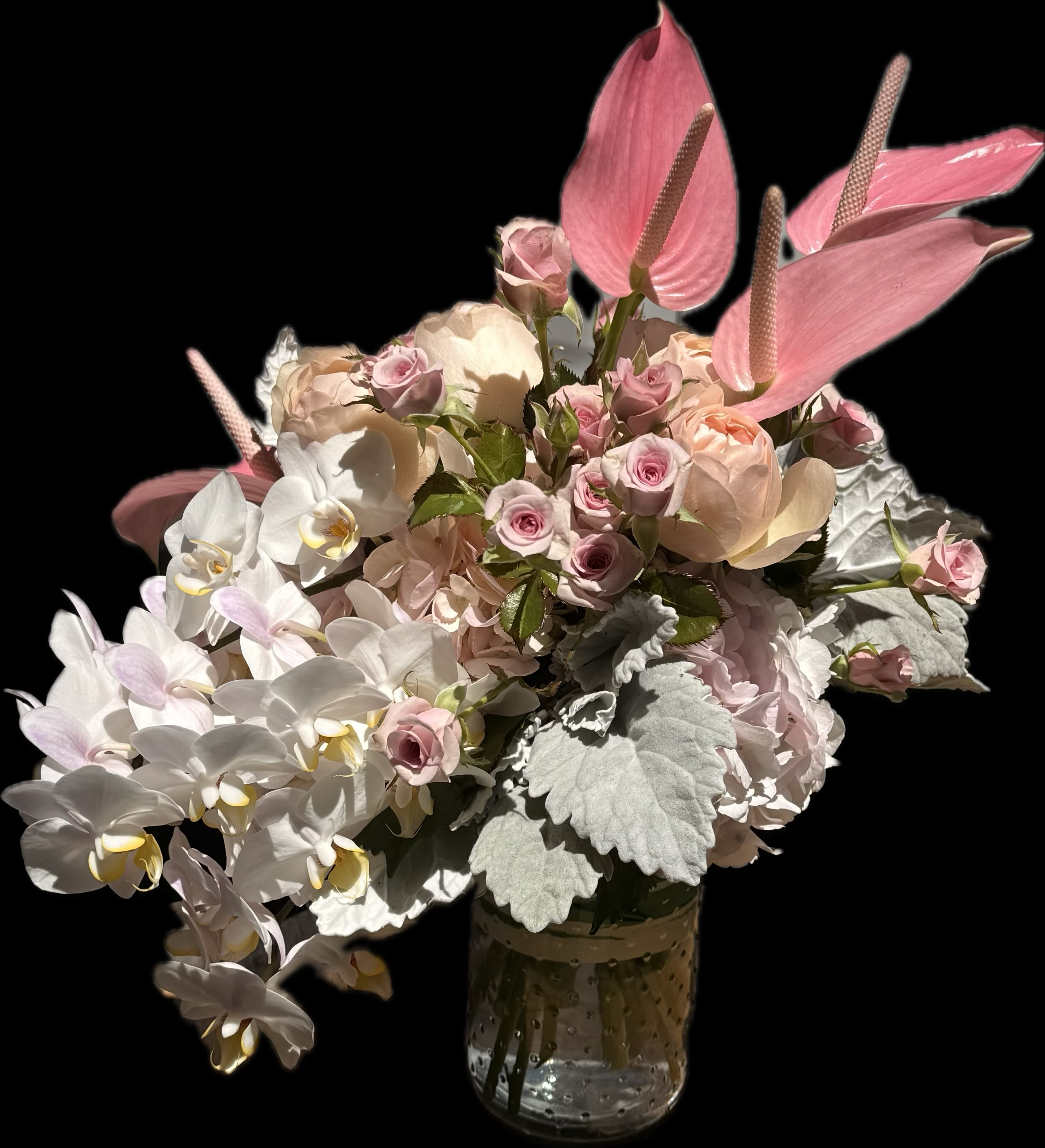 Blush Elegance Arrangement  -  Delicate. Luxe. Unforgettable. This couture arrangement features graceful white phalaenopsis orchids, sculptural pink anthuriums, lush garden roses, and blush spray roses nestled in soft hydrangeas and dusty miller. Designed in a textured glass vase with a silk ribbon accent, Blush Elegance is perfect for romantic moments, luxury gifting, or intimate events. Handcrafted with care in San Francisco.  Size: Approx. 18–20” tall Best for: Anniversary, Engagement, Luxury Gift, Wedding Decor Available for same-day delivery in SF &amp; surrounding areas 