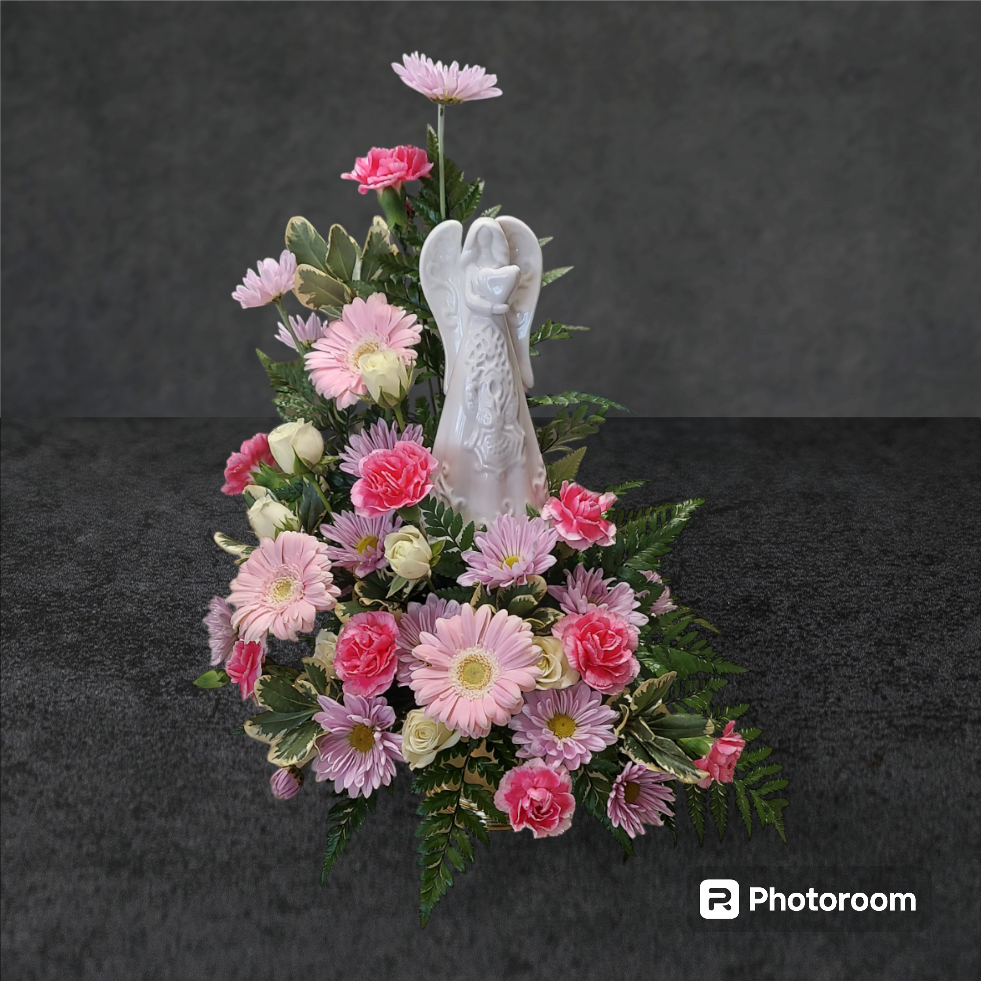 Heaven Sent Heaven Sent - A precious, porcelain angel is surround by pink, white, and lavender blooms. FLOWER COLORS WILL VARY WITH AVAILABILITY. Angel measures 7" H x 3.5" W. Over all arrangement size: 15" H x 13"W.