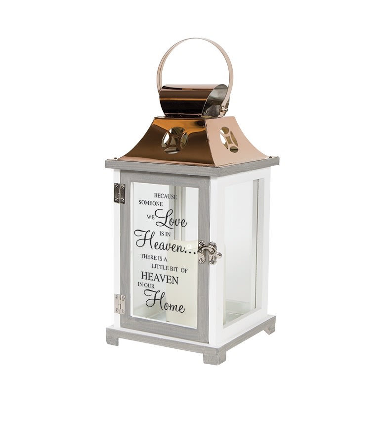 &quot;Heaven&quot; Lantern - White - This decorative keepsake lantern reads &quot;Because someone we love is in Heaven, there is a little Heaven in our home&quot;. It is made of white composite wood with a copper finish top and is 12&quot; tall. It contains a flameless LED candle. Suitable for hanging or use as a freestanding item. Recommended as an accent in floral arrangements for many occasions. It can be purchased individually or with an accompanying floral arrangement (Deluxe).