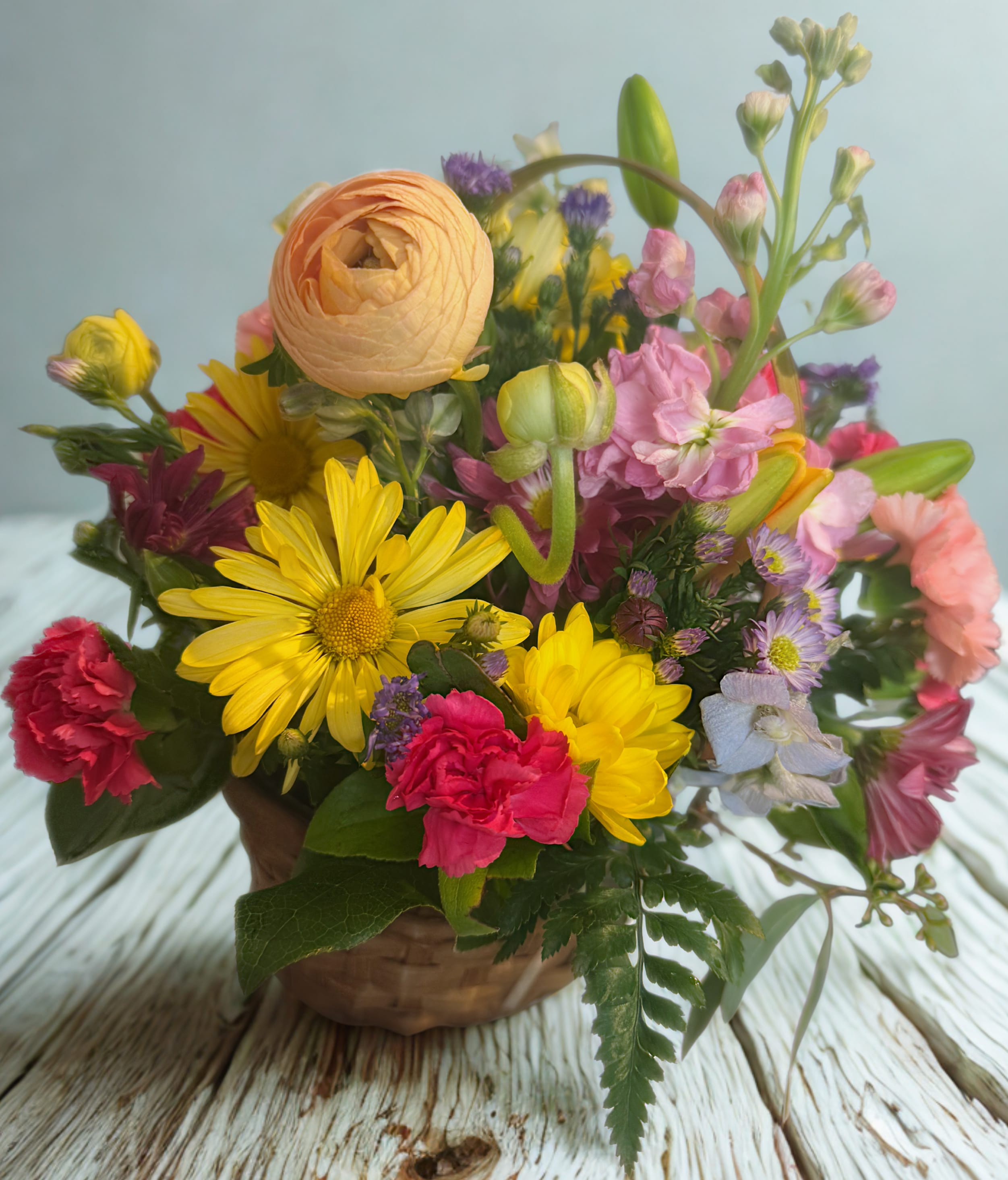 Sunshine Jubilee - Sunshine Jubilee bursts with bold, cheerful color in a lively mix of yellow, pink, peach, and purple blooms. This joyful arrangement brings the energy of a sunny garden party to any space, making it perfect for celebrations or simply brightening someone’s day. 
