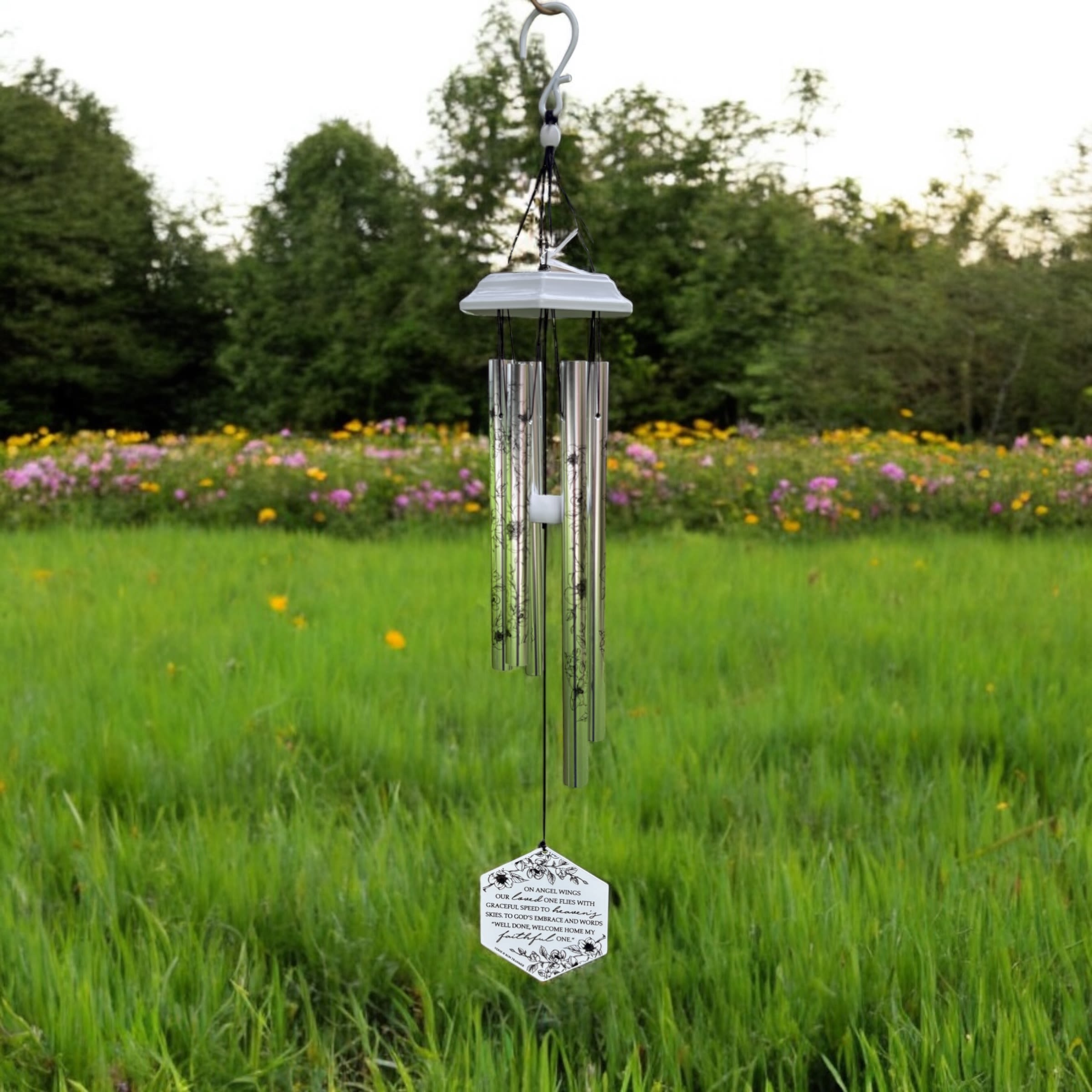 Angel Wings Chime - Grace you garden with the tranquil sounds of this 28&quot; wind chime featuring the heartfelt sentiment &quot;On Angels Wings&quot;.  The wind catcher is adorned with a delicate floral motif and this comforting verse:  &quot; on angel's wings our loved ones fly with graceful speed to Heaven's sky. To God's embrace and words we long to hear, 'Well done, welcome home my dear.&quot;