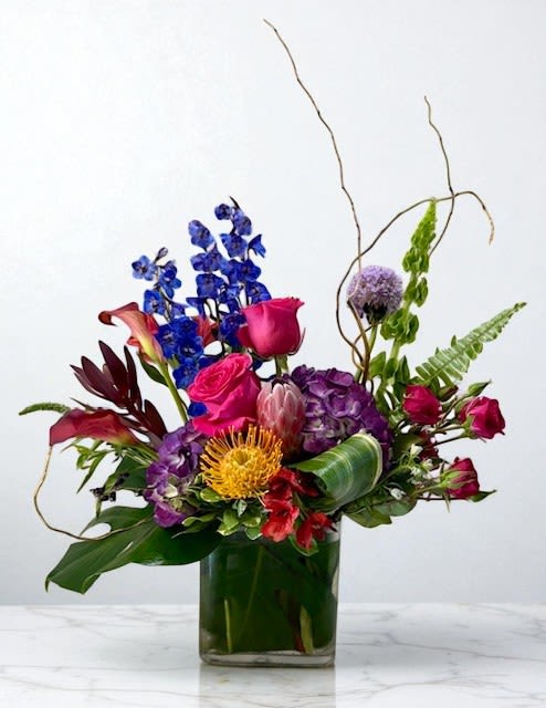 Dare to Be Bold  - A striking arrangement bursting with hot pink and rich jewel tones, designed to turn heads and celebrate life’s vibrant moments. Elegant yet daring, this piece blends vivid colors with refined style—perfect for any occasion that calls for something unforgettable.