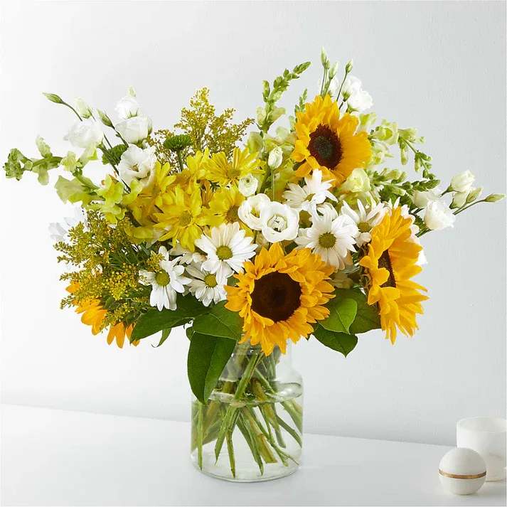 Hello Sunshine Bouquet (exquisite) Hello Sunshine Bouquet (exquisite) - Give a dose of sunshine in bloom. This stunning bouquet is teeming with rays of sunflowers, textured snapdragons and darling daisy poms to deliver the perfect pick–me–up for an occasion or as a treat to yourself. Details 20"h x 19"w