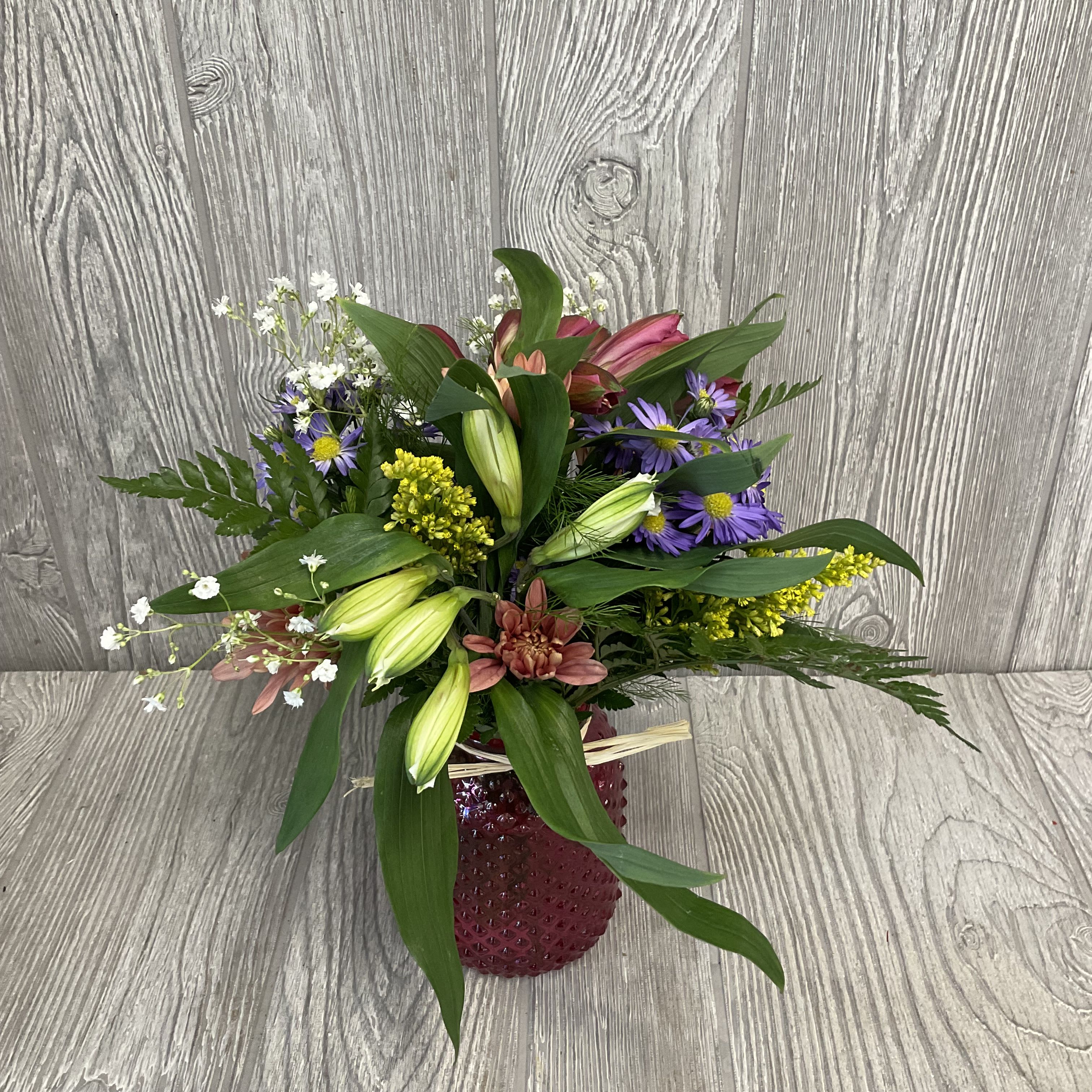Lil Wild - Wildflower arrangement designed to look like the flowers were fresh picked along the way. Vase color and flowers may vary. 
