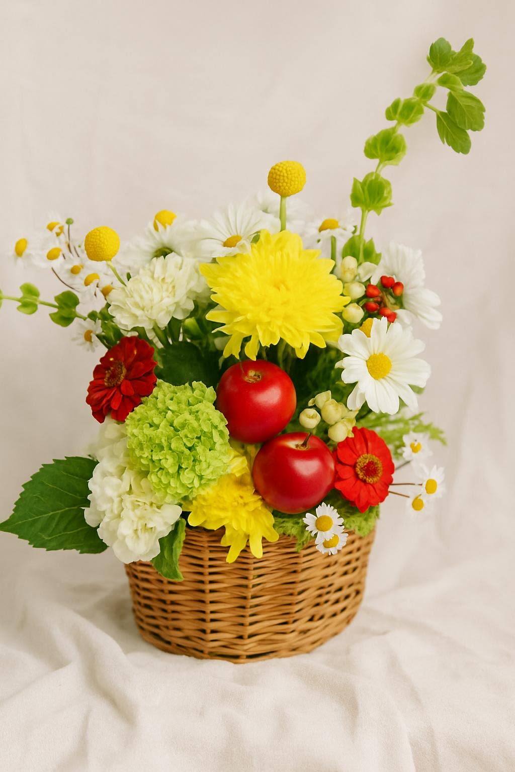 Rustic Charm Apple & Blossom Basket Rustic Charm Apple & Blossom Basket - This charming hand-crafted flower basket bursts with vibrant colors and natural beauty, making it the perfect gift or centerpiece for any occasion. Featuring cheerful yellow chrysanthemums, delicate white daises, lush green hydrangeas, bright red zinnias & fresh chamomile blooms. The arrangement is accented with seasonal berries and striking red apples for a unique, eye-catching touch. Presented in a rustic woven wicker basket, this bouquet blends freshness, elegance, and a hint of countryside charm - ideal for birthdays, thank yous, get-well wishes or simply brightening someone's day. With it's symbolic red apples and cheerful blooms, this arrangement also makes a thoughtful gift for teachers and a perfect way to celebrate the back-to-school season.