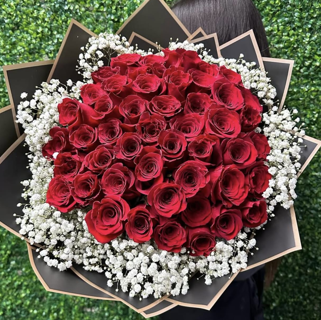50 Roses Wrap With Babies Breath - 50 of our premium red roses wrapped with babies breath. Accompanied by modern wrap.  Upgrade your bouquet with a banner of 2 to 3 words to say what is in your heart.  (Banner Sold Separately) Wrapping paper might change upon availability to match flowers. 