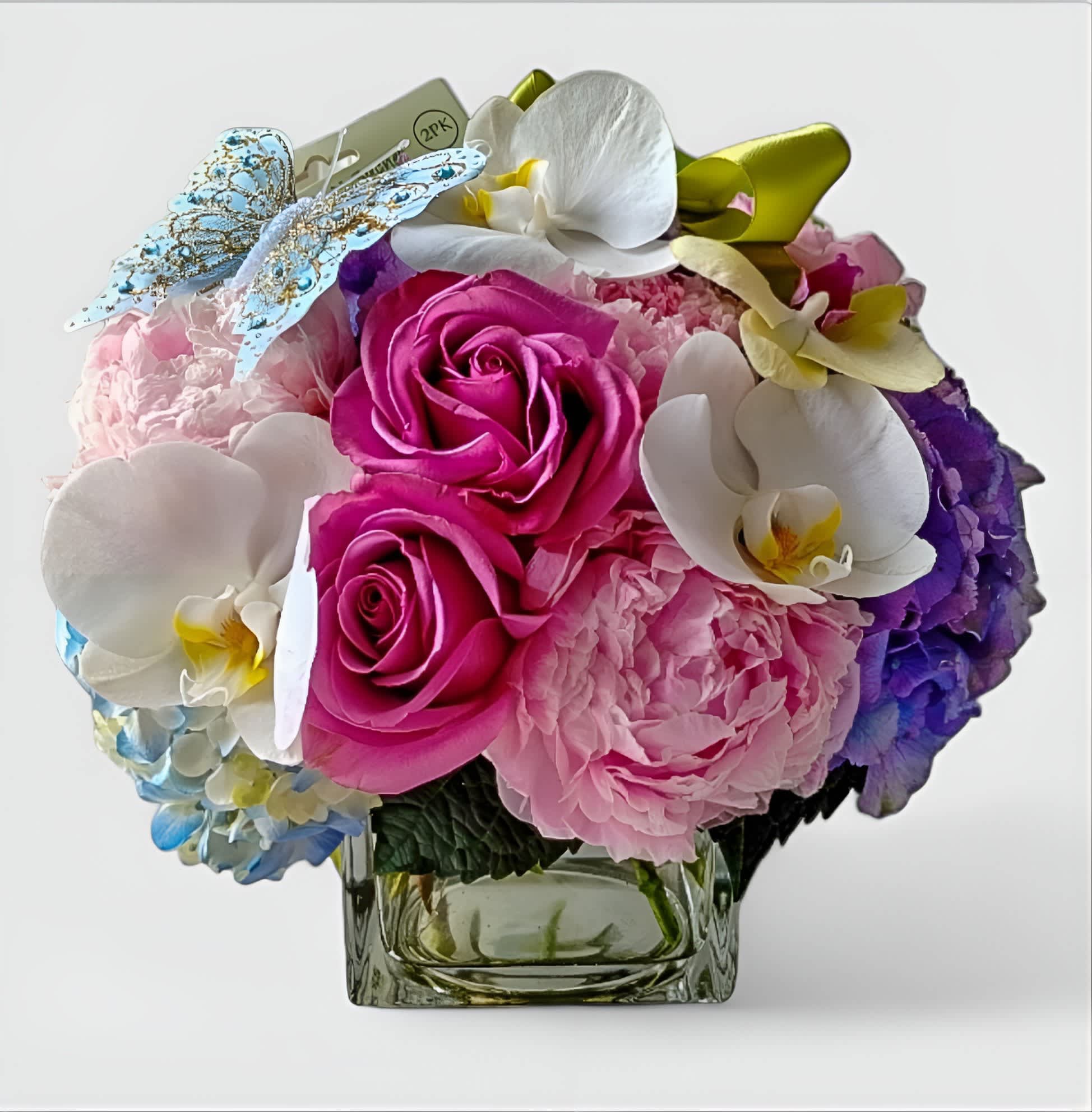 Sending Smiles Bouquet Designer's Choice Sending Smiles Bouquet Designer's Choice - Designer's choice; made beautifully from my pastel blossom selection of the day roses orchids hydrangeas and more arranged in a modern glass cube vase. Perfect to send today to make them smile. Always made extra special and unique each and every time. Send happiness.